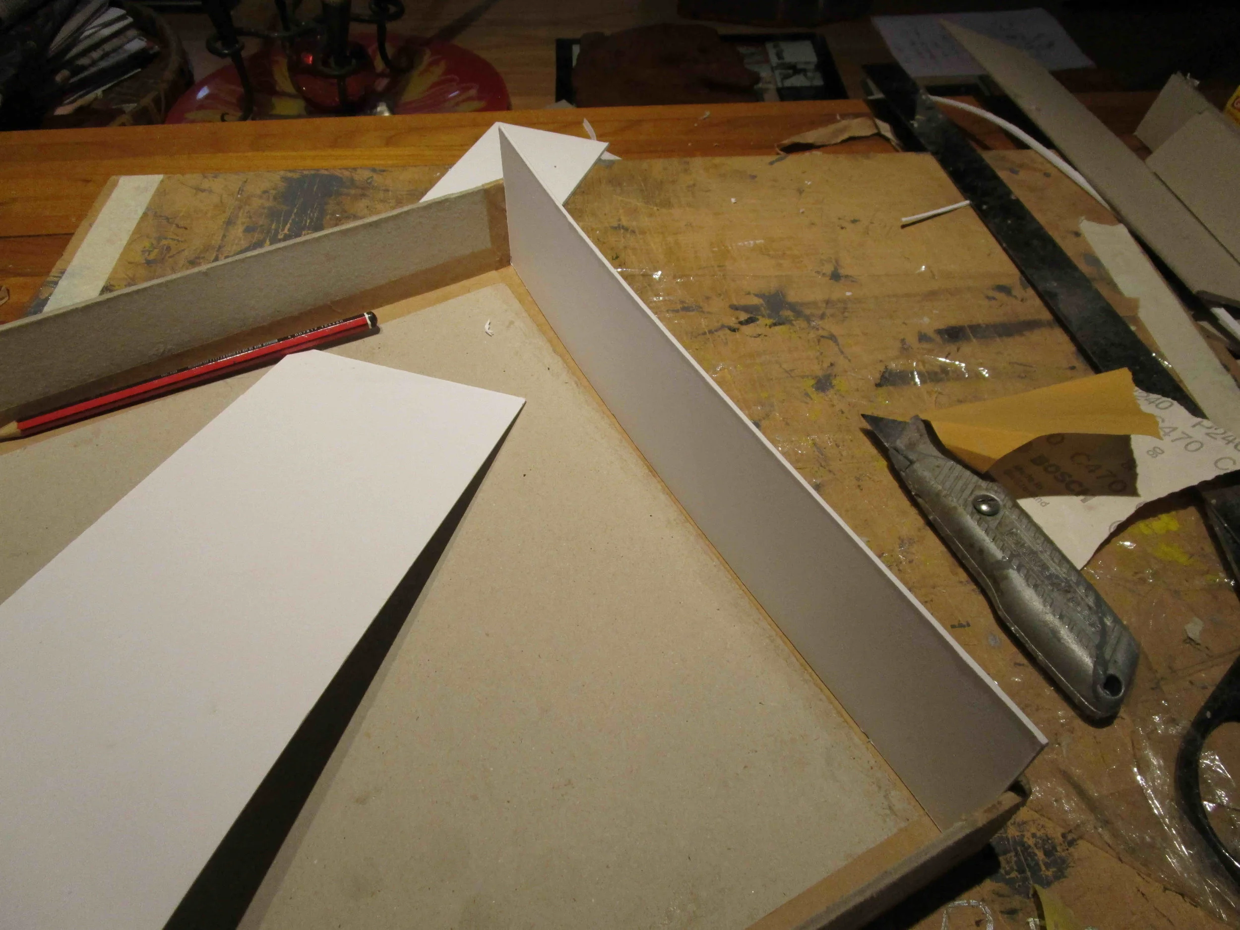 Fitting cut lid guides. Acid free photo glue to avoid warping, PVA to help the budget. When fitting the box lid, ensure that the lid is fitted in place on the box before gluing the last 2 sides, to ensure a snug fit.