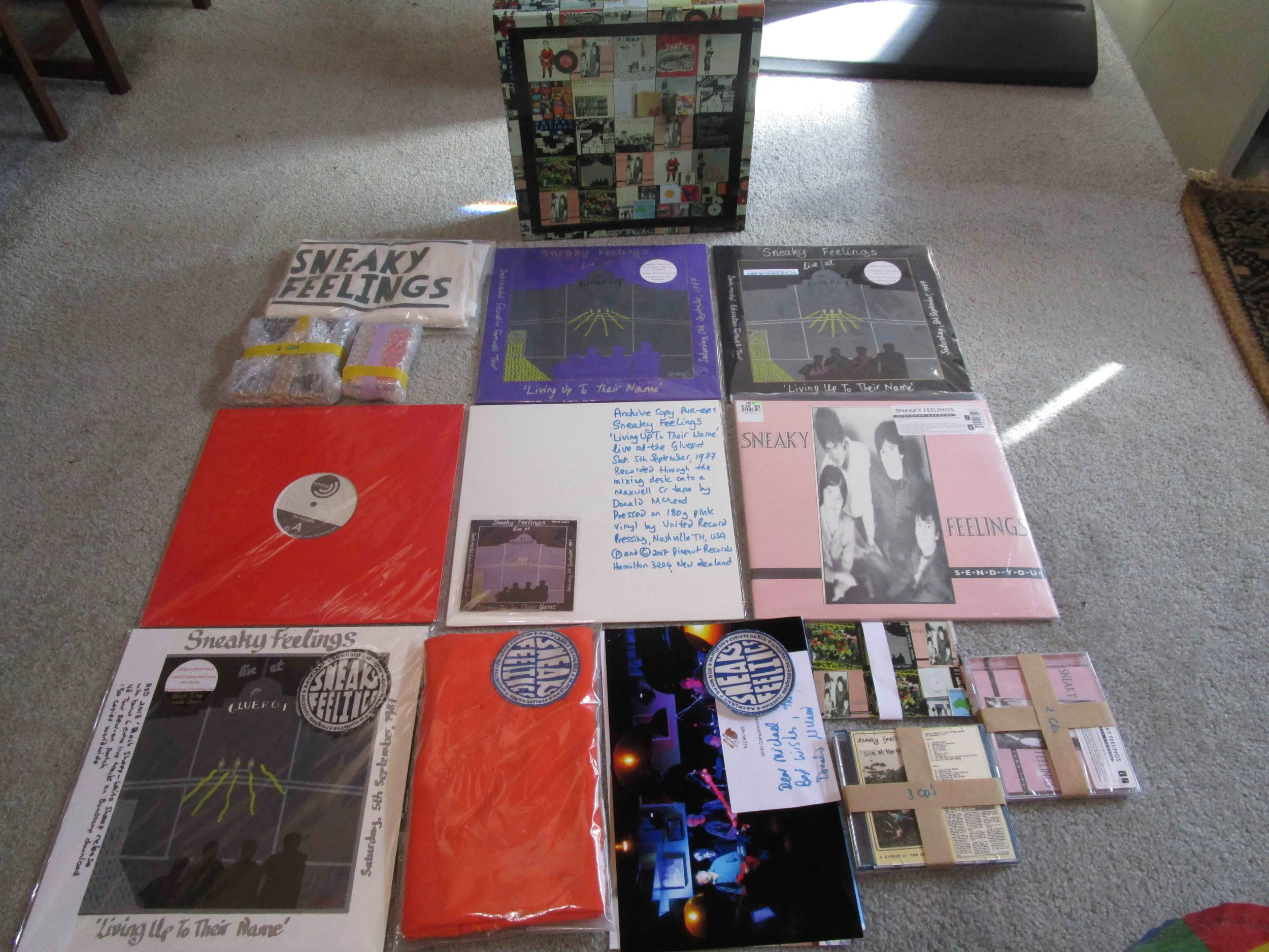 Contents designed to fit this box, comprising 6 LPs, 7 CDs, 1 cassette tape, 2 t-shirts, and various posters, photos, and tour collections.