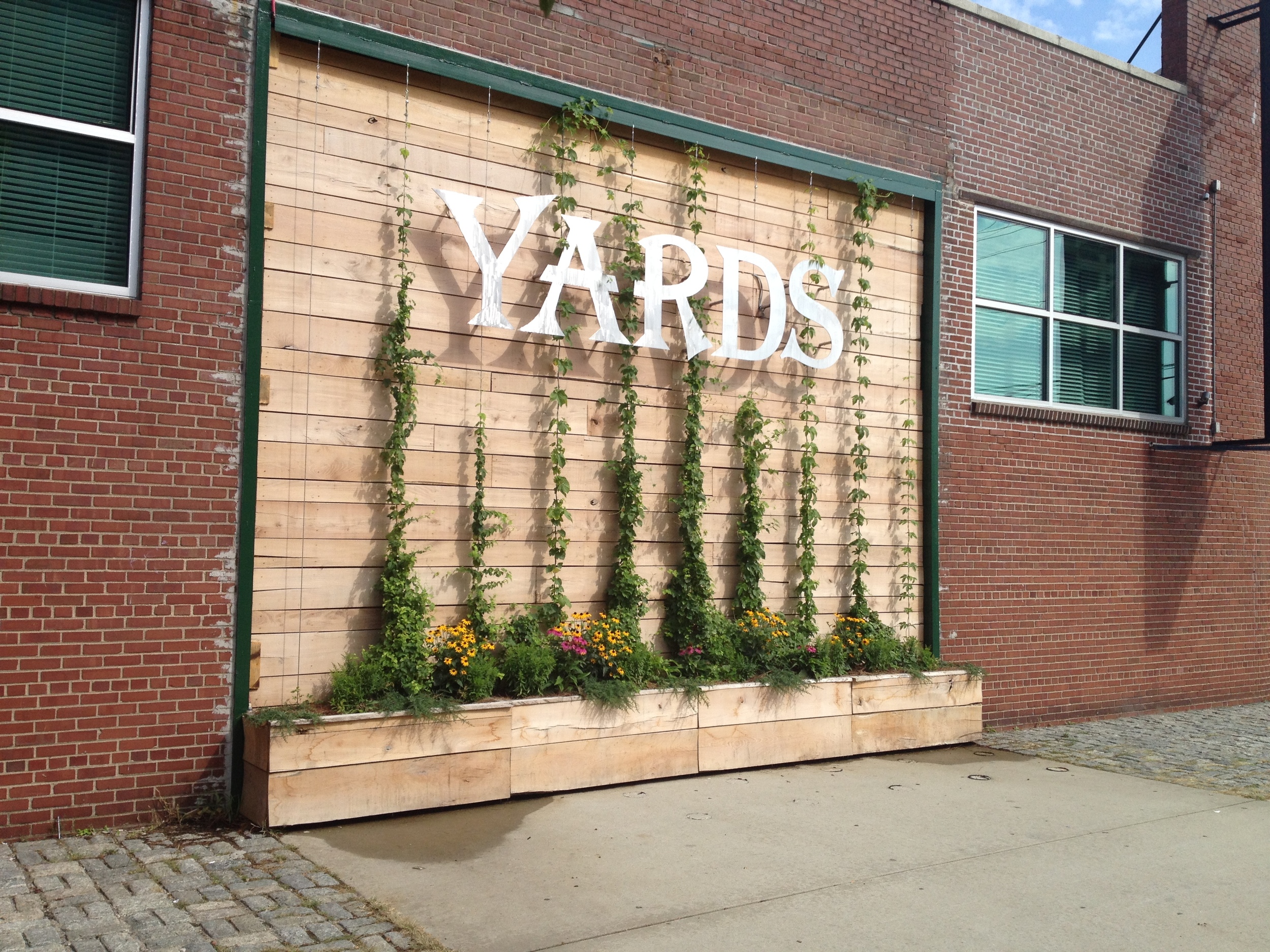 Sign and planters with hops.