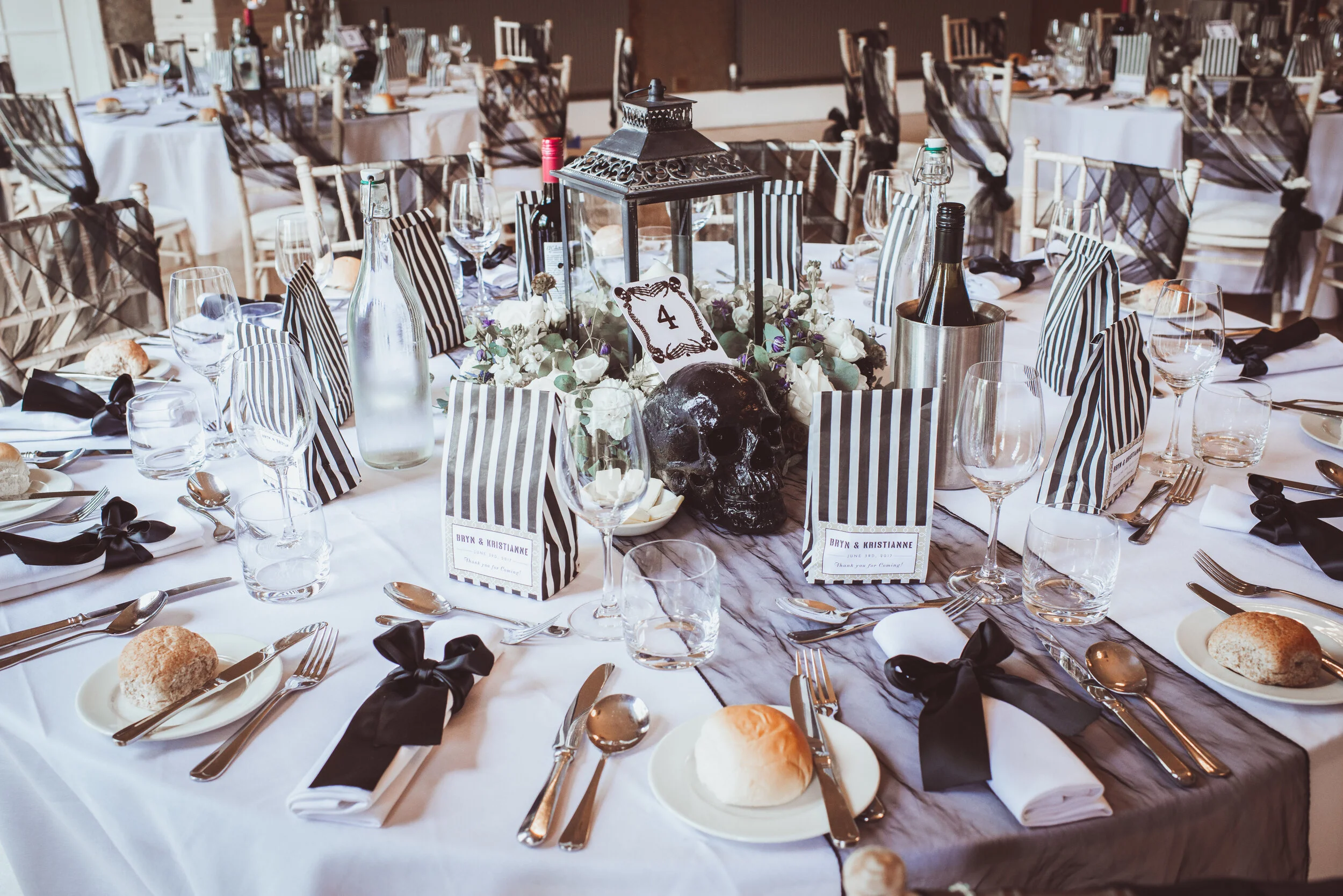 I can’t take the credit for the styling here, but I made these bespoke skull table numbers which look awesome in this monochromatic set up.