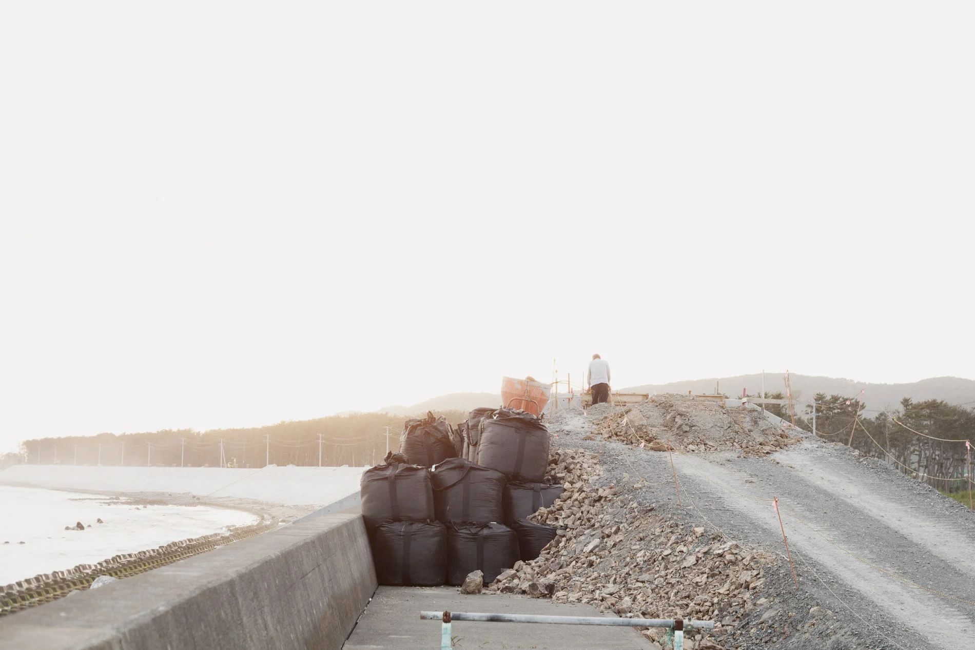 Title: Prayer #14 (man on the reinforced seawall)