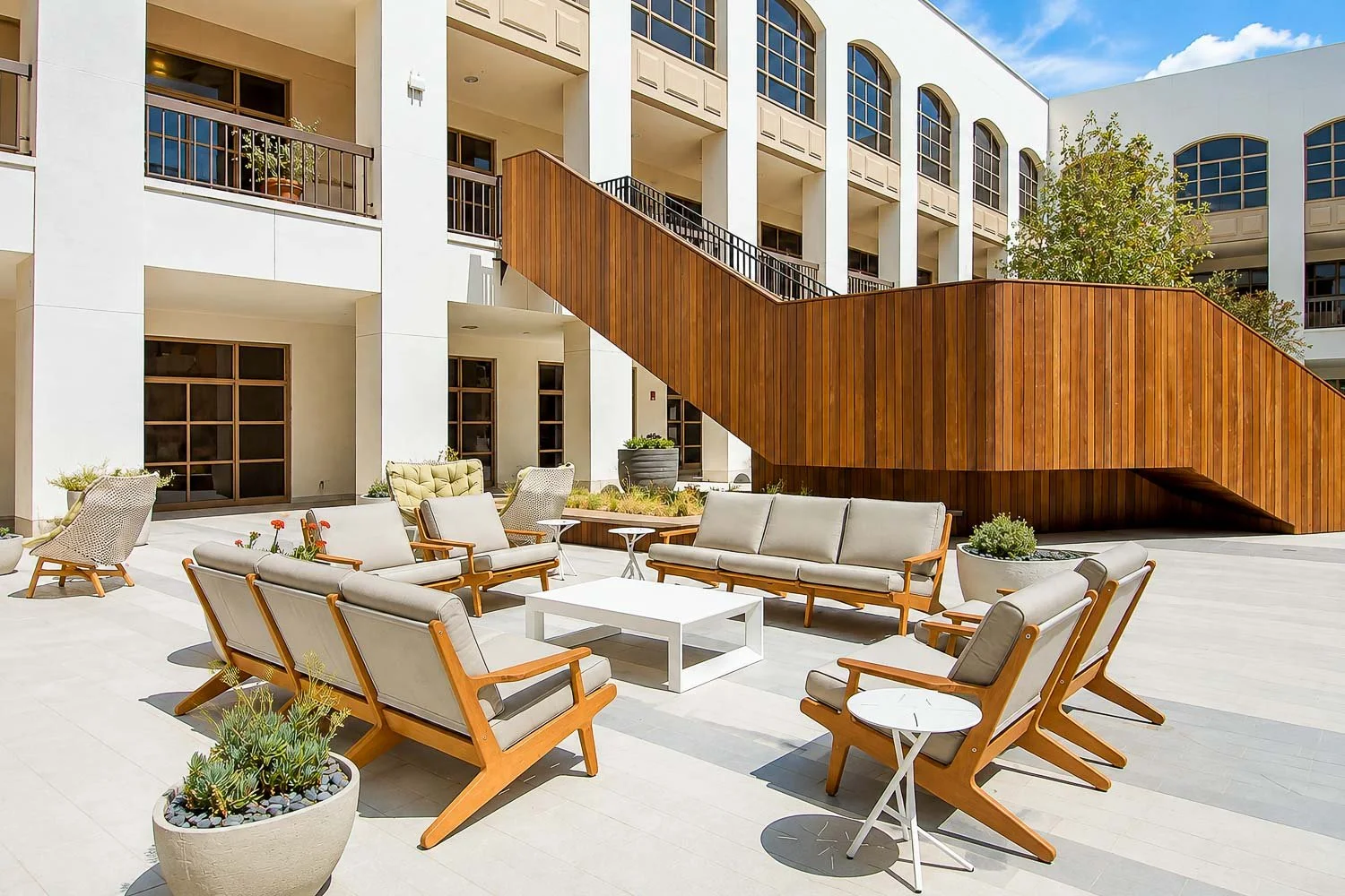 Outdoor courtyard seating beside the wood staircase at The Park Calabasas.