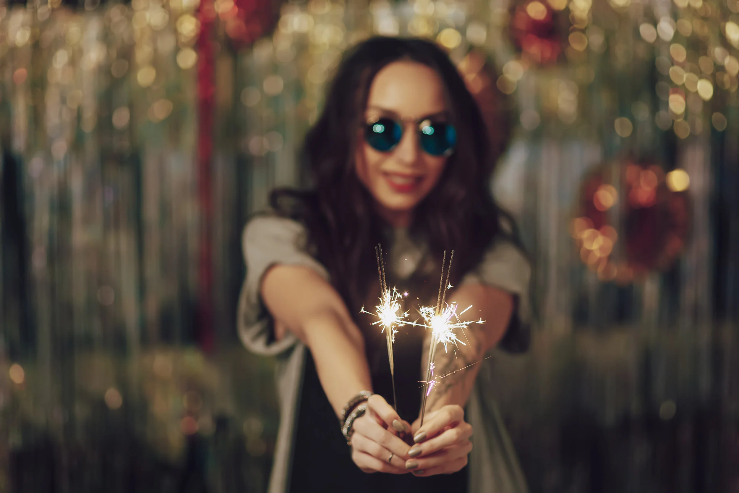 focus-on-woman-hands-holding-sparklers-PPYQHGC.jpg