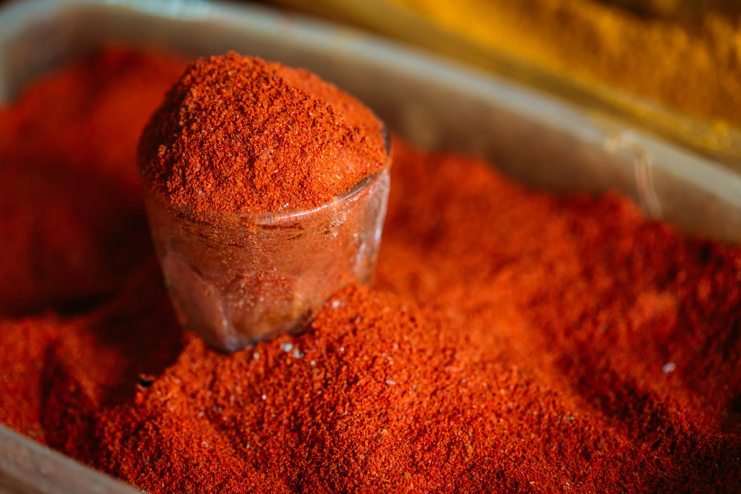 close-glass-with-powdered-paprika-cayenne-pepper-PUAUGKT.jpg