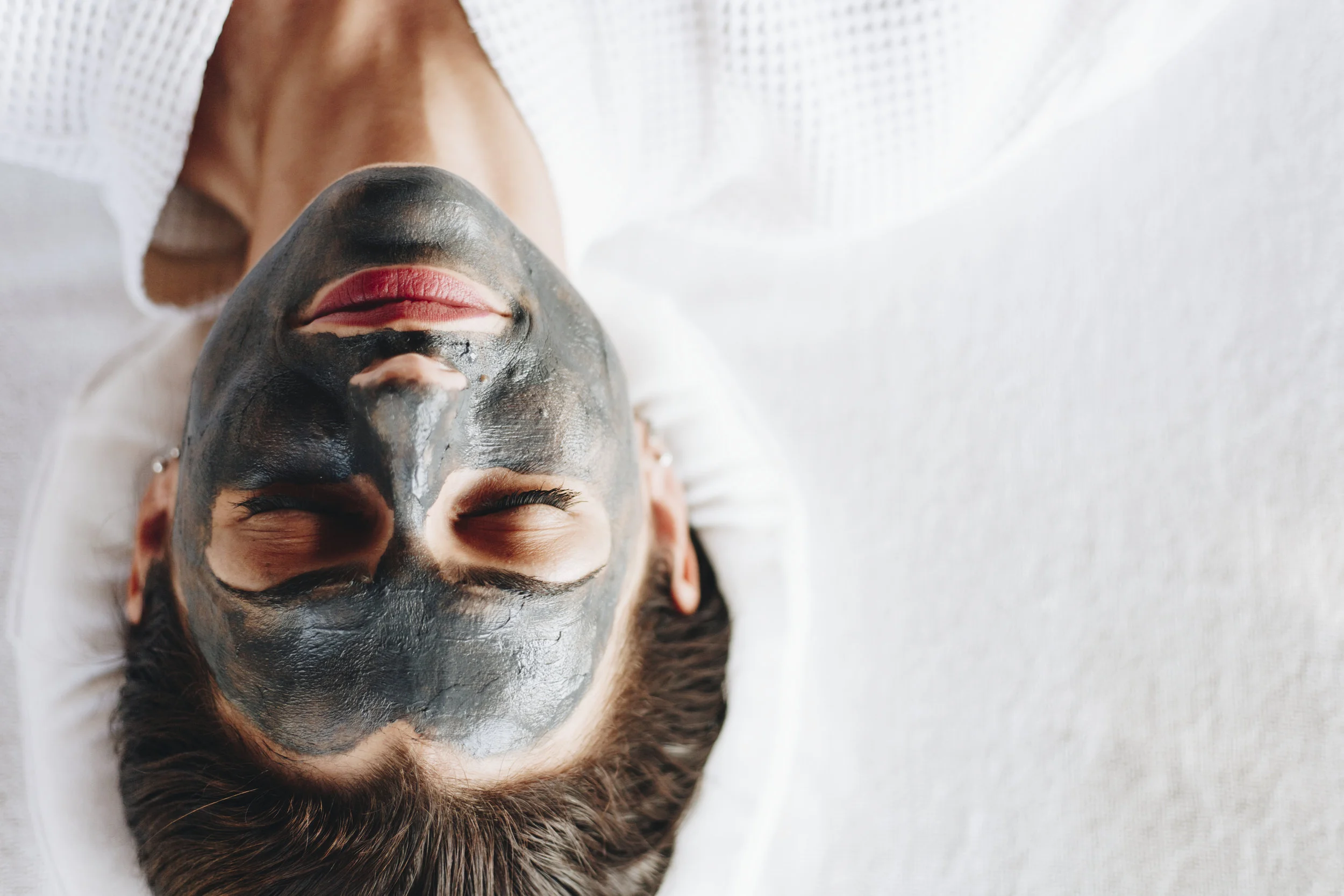 woman-relaxing-with-a-charcoal-facial-mask-QXUBHGR.jpg