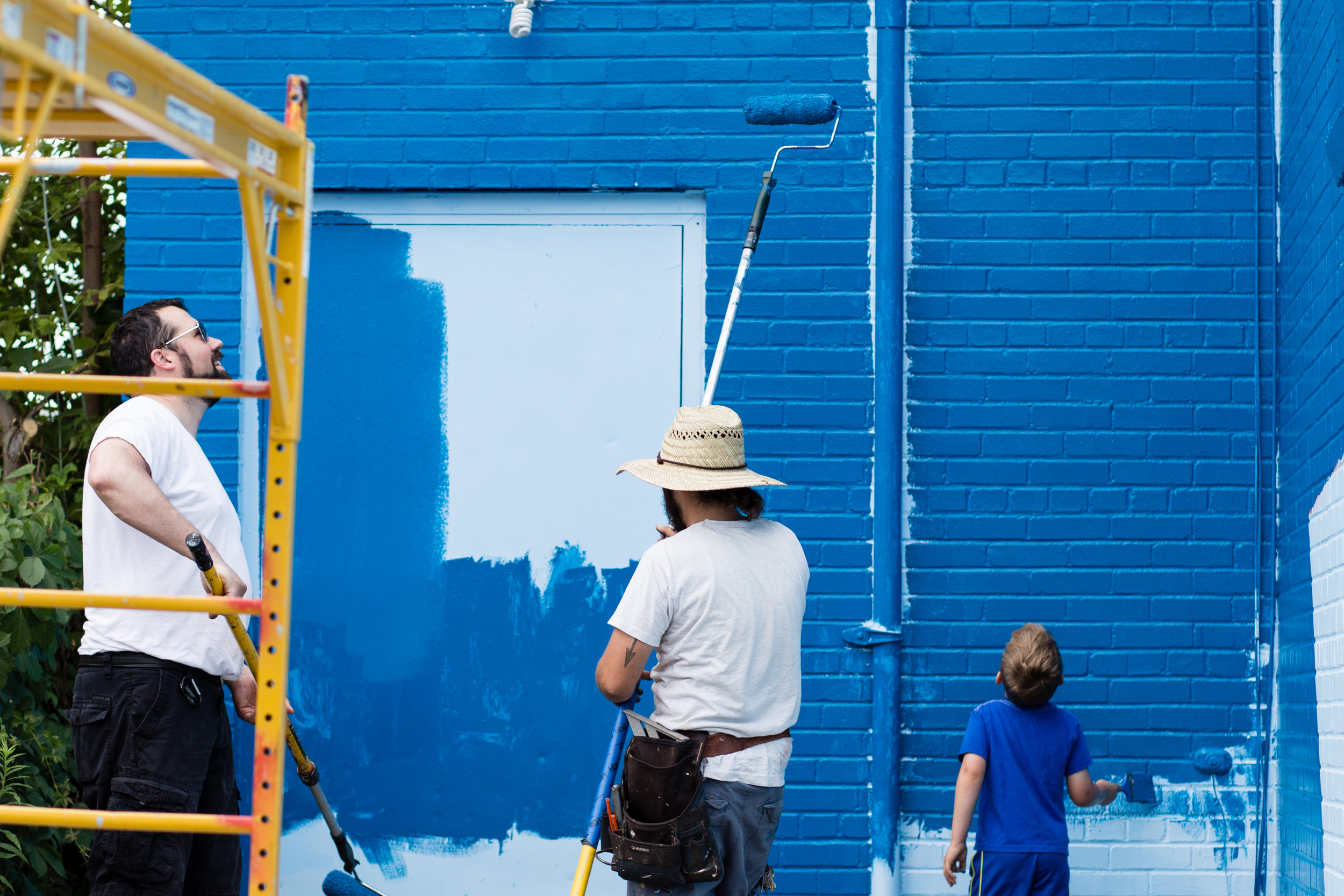 Chris and a few community members working on the first coat together.&nbsp;&nbsp;