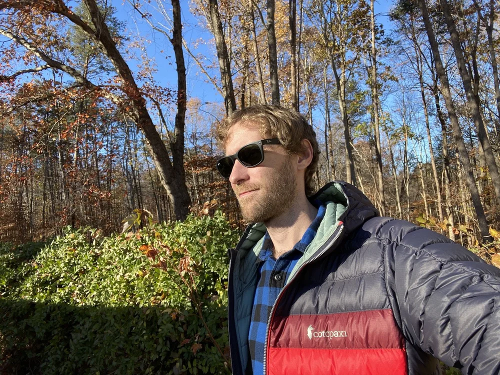  Seth sporting the Cotopaxi Fuego down jacket with a retro color pattern. 