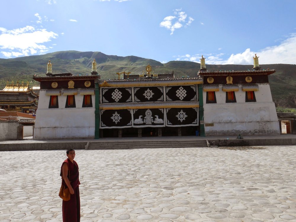  A Tibetan Buddhist monk stands outside Rongwo Monastery. 