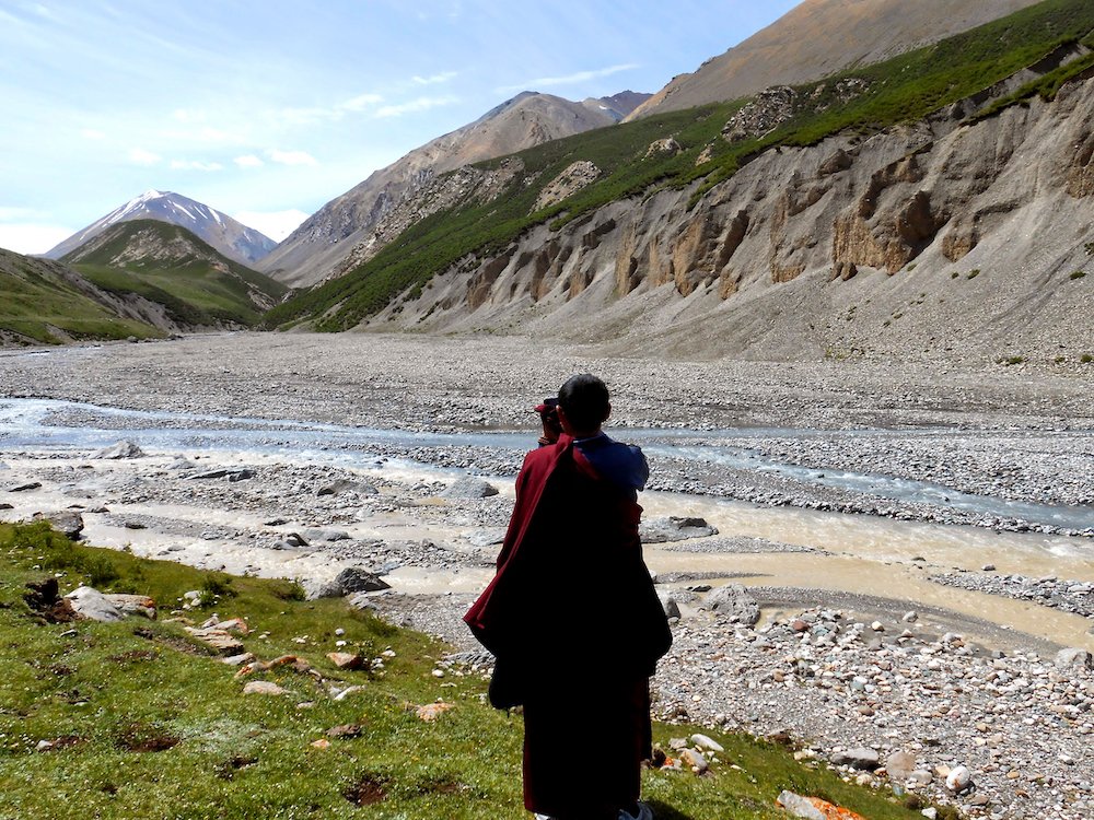  A Tibetan Buddhist monk takes a photo of the scenery at Mount Amnye Machen. 