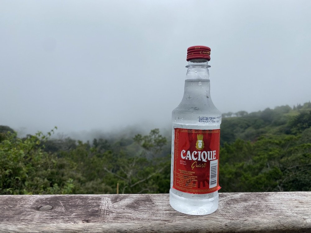  A standard bottle of Cacique Guaro against a misty backdrop of Monteverde’s mountains. 
