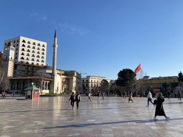  People walk about in Skanderbeg Square at the center of Tirana. 