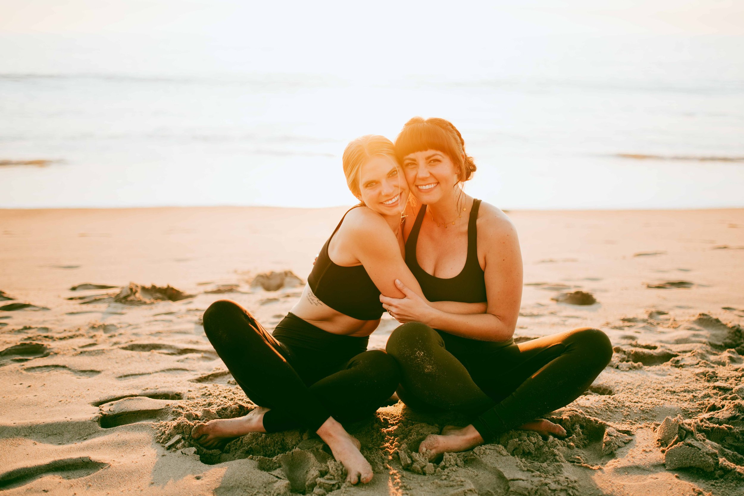  Young women practice yoga poses on San Clemente State Beach for a photoshoot 