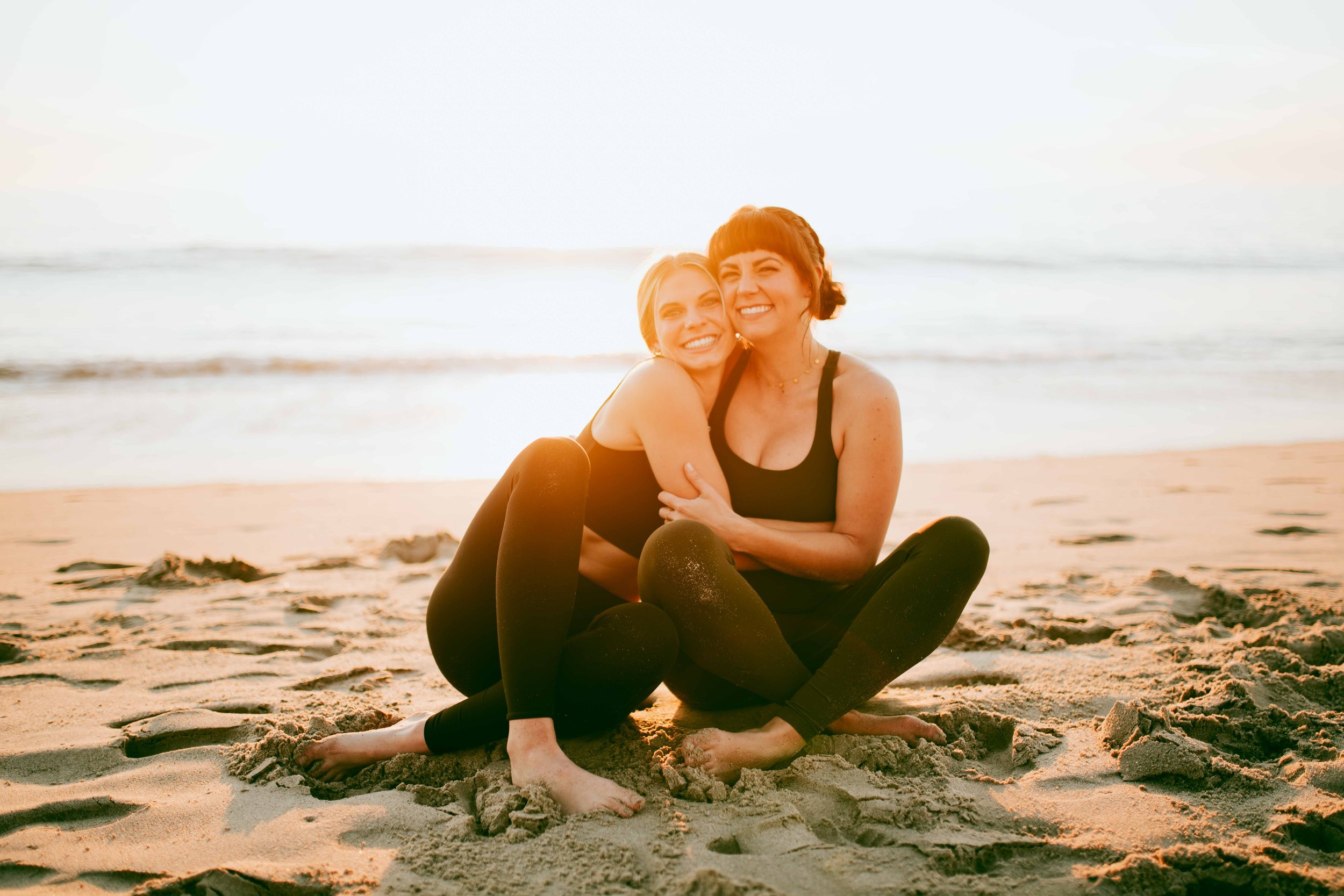  Young women practice yoga poses on San Clemente State Beach for a photoshoot 