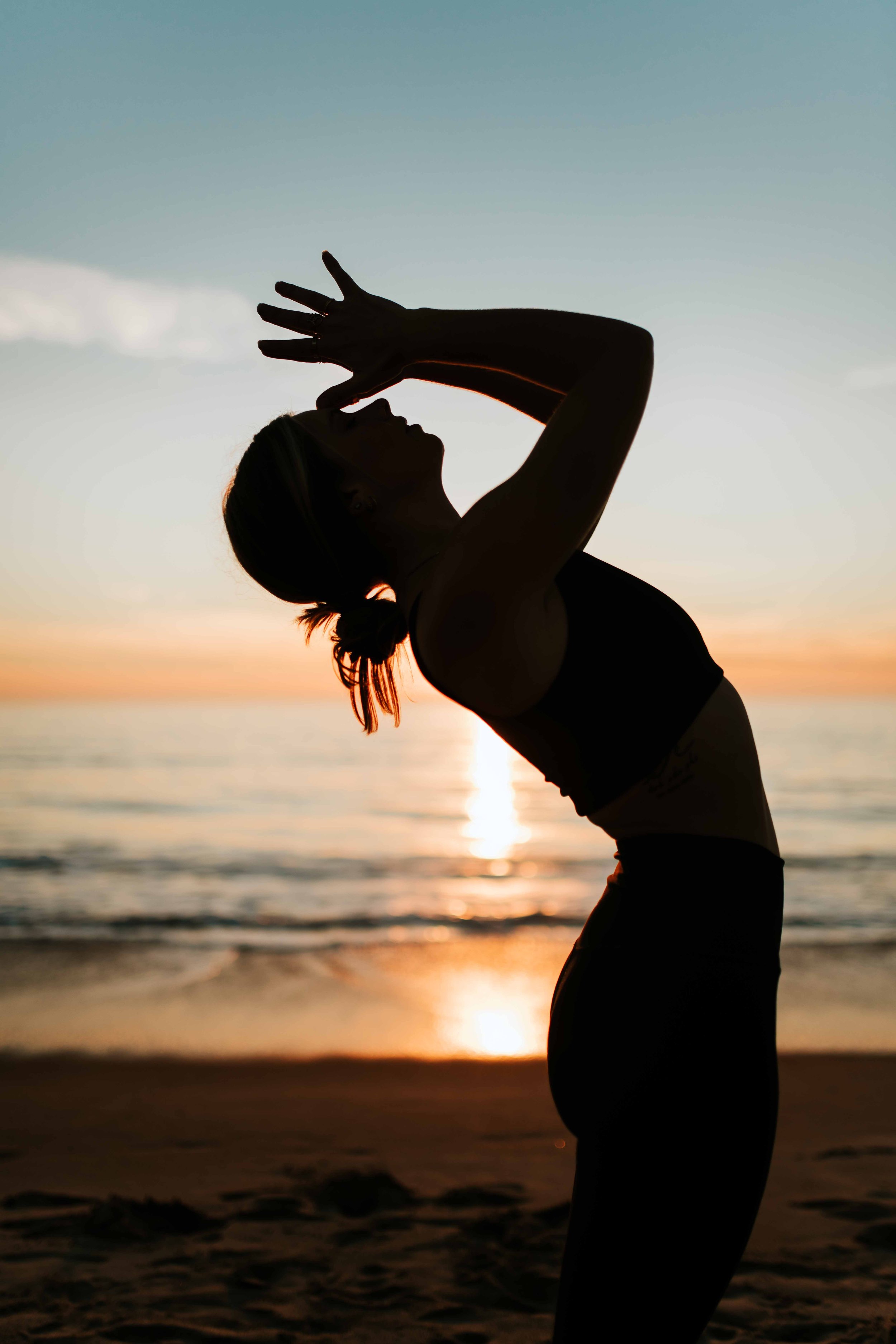  Young women practice yoga poses on San Clemente State Beach for a photoshoot 