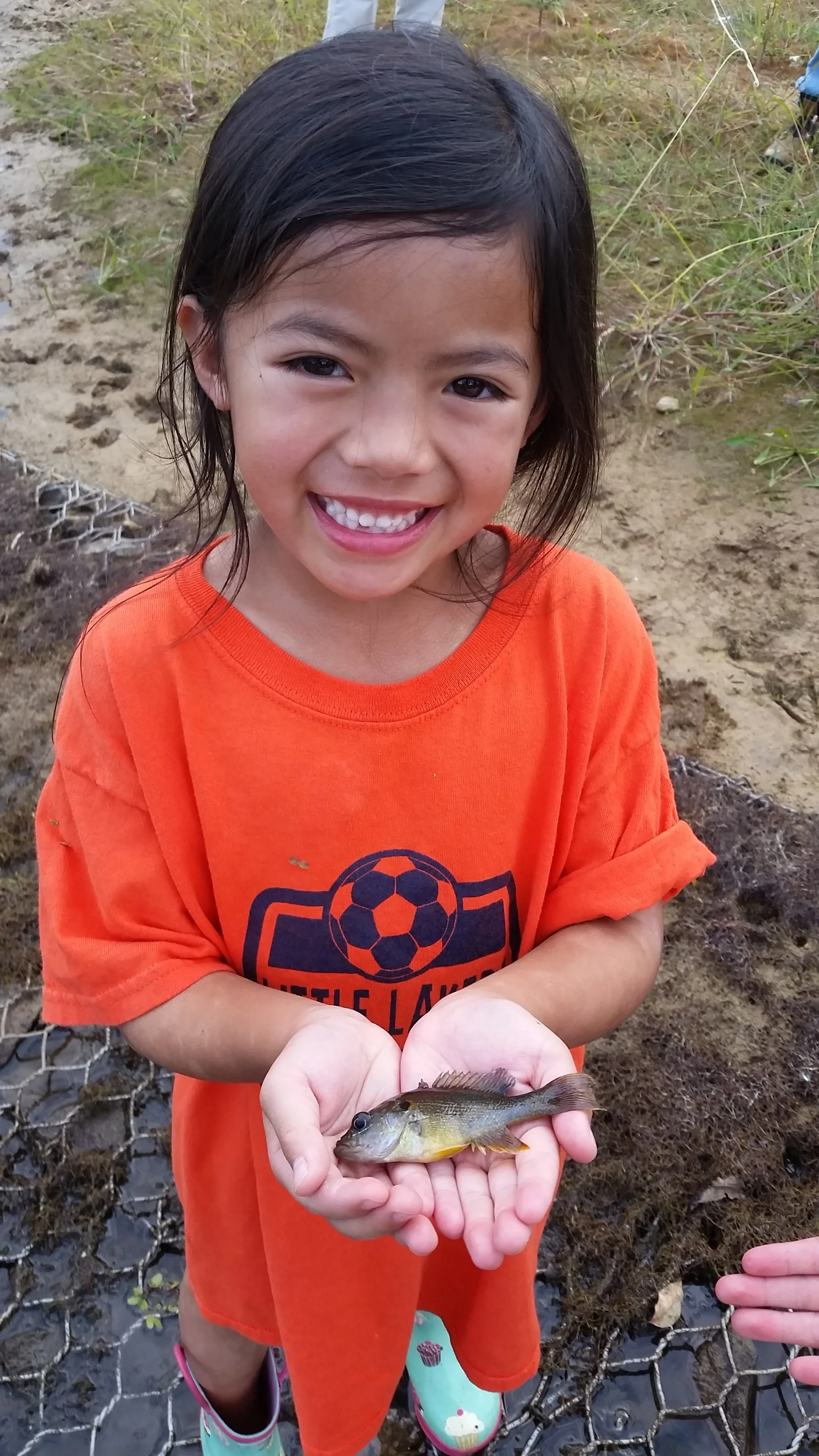 The smile tells it all .... first fish on her own hand tied fly.