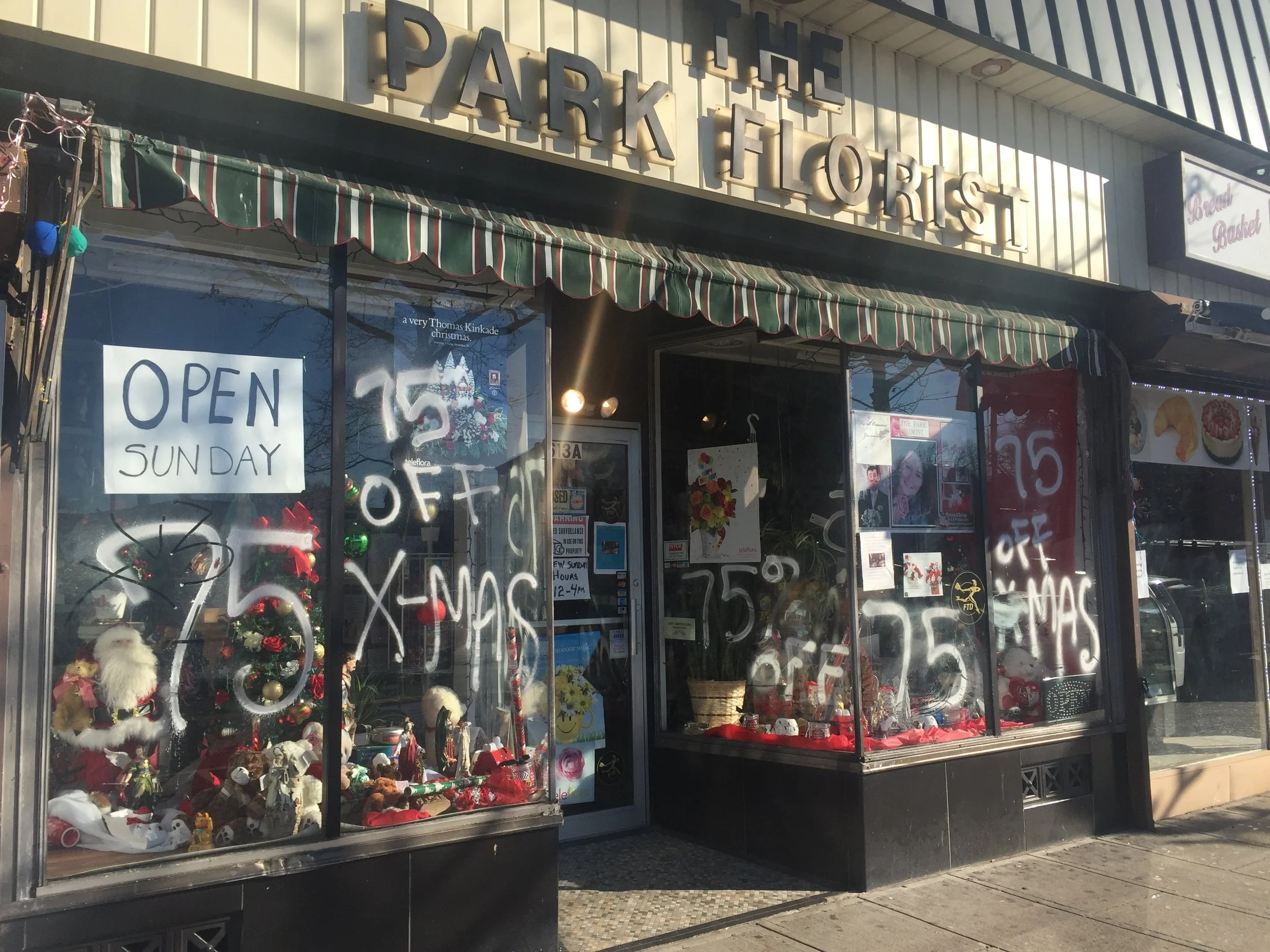 The Park Florist, Park Avenue, Plainfield has an attractive wall sign, a traditional retractable awning and a well decorated display.