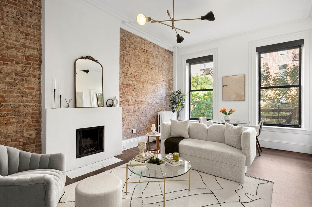 This home showcases a spacious living room with natural lighting and exposed brick. Emphasizing the homes natural features, we used a light to neutral color palette to highlight the features rather than distract from them. ⁣
148 West 16th St. 
Agent: