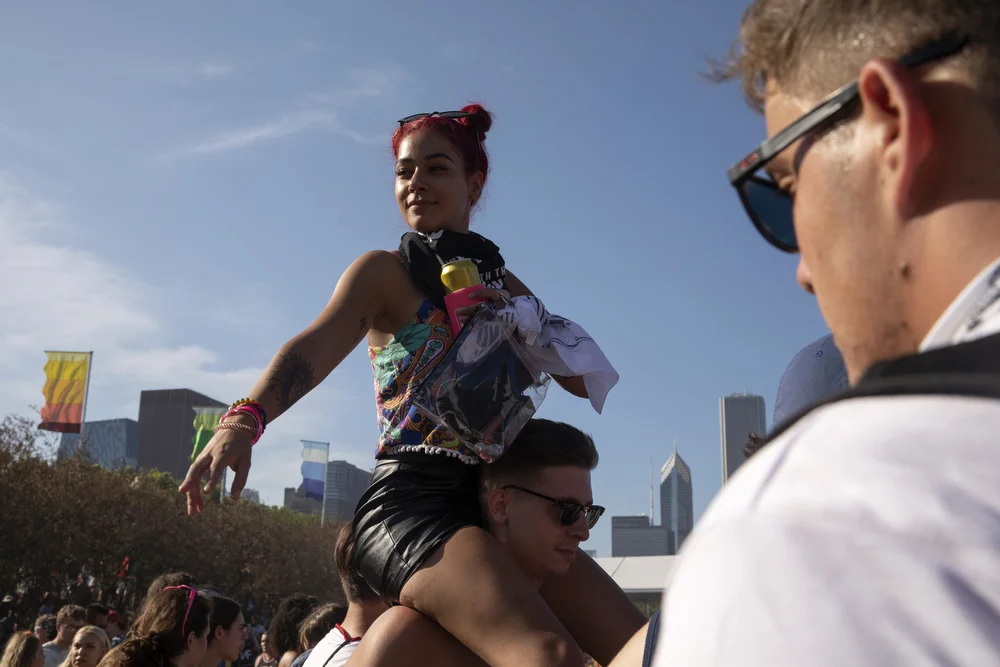 A festival goer sits on shoulders during 21 Savage's performance at Lollapalooza Friday, August 2, 2019, in Chicago. (Erin Hooley/Chicago Tribune)