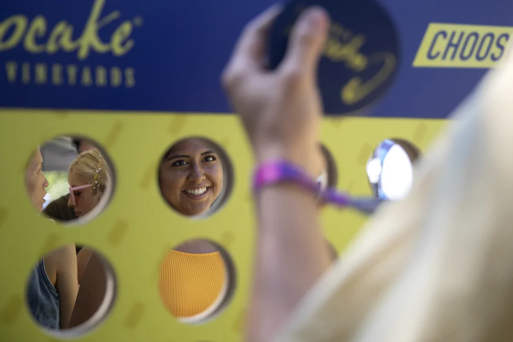 Isabella Yataco plays an over-sized game of connect four at Lollapalooza Thursday, August 1, 2019, in Chicago. (Erin Hooley/Chicago Tribune)