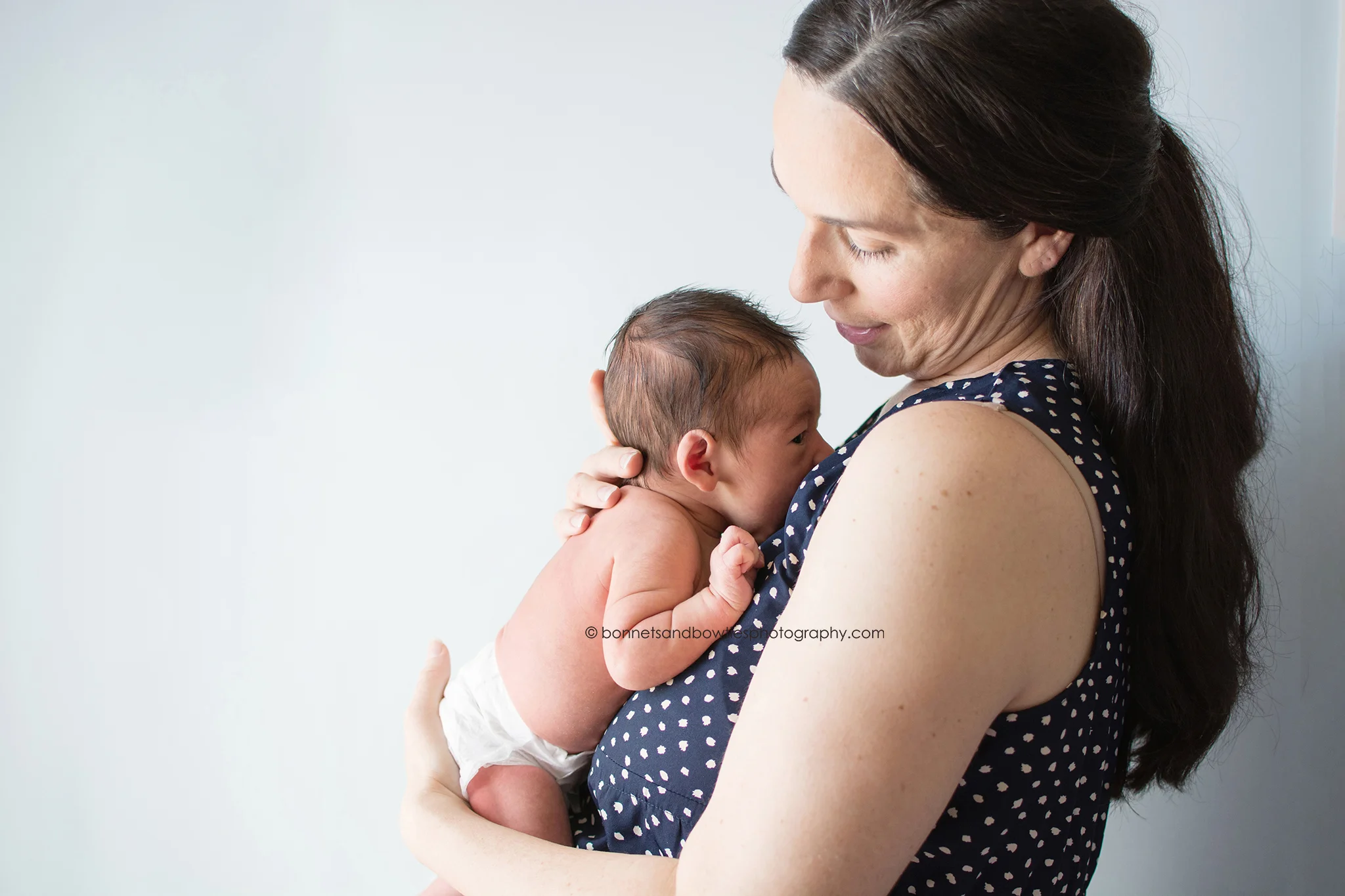 mother and newborn son blue wall.jpg