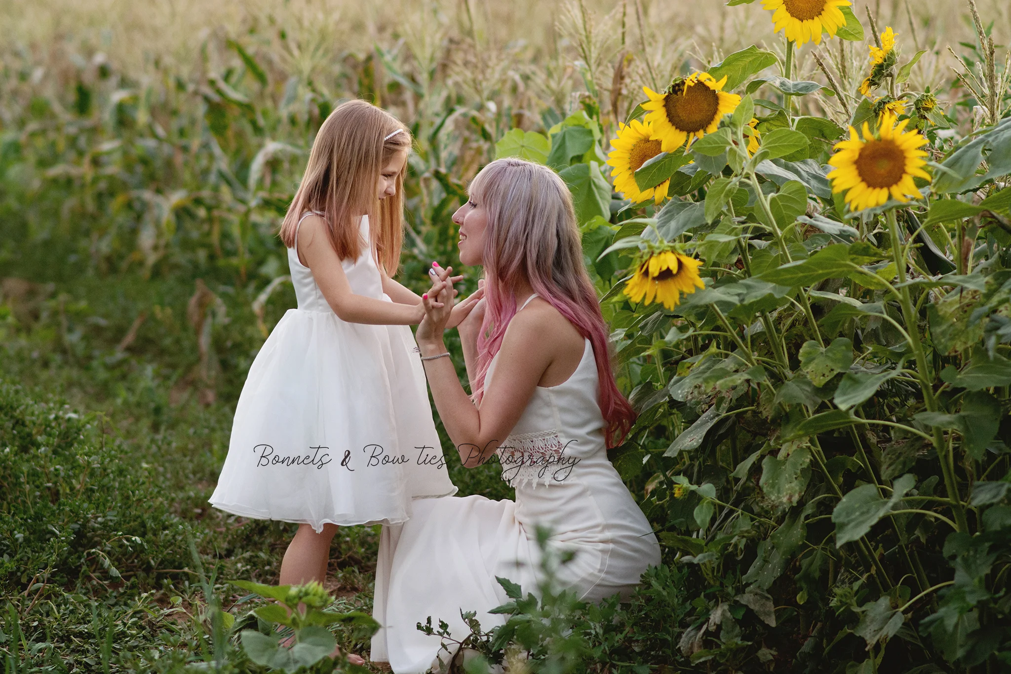 mother and daughter photo shoot in sunflowers at Lehman's feed store.jpg