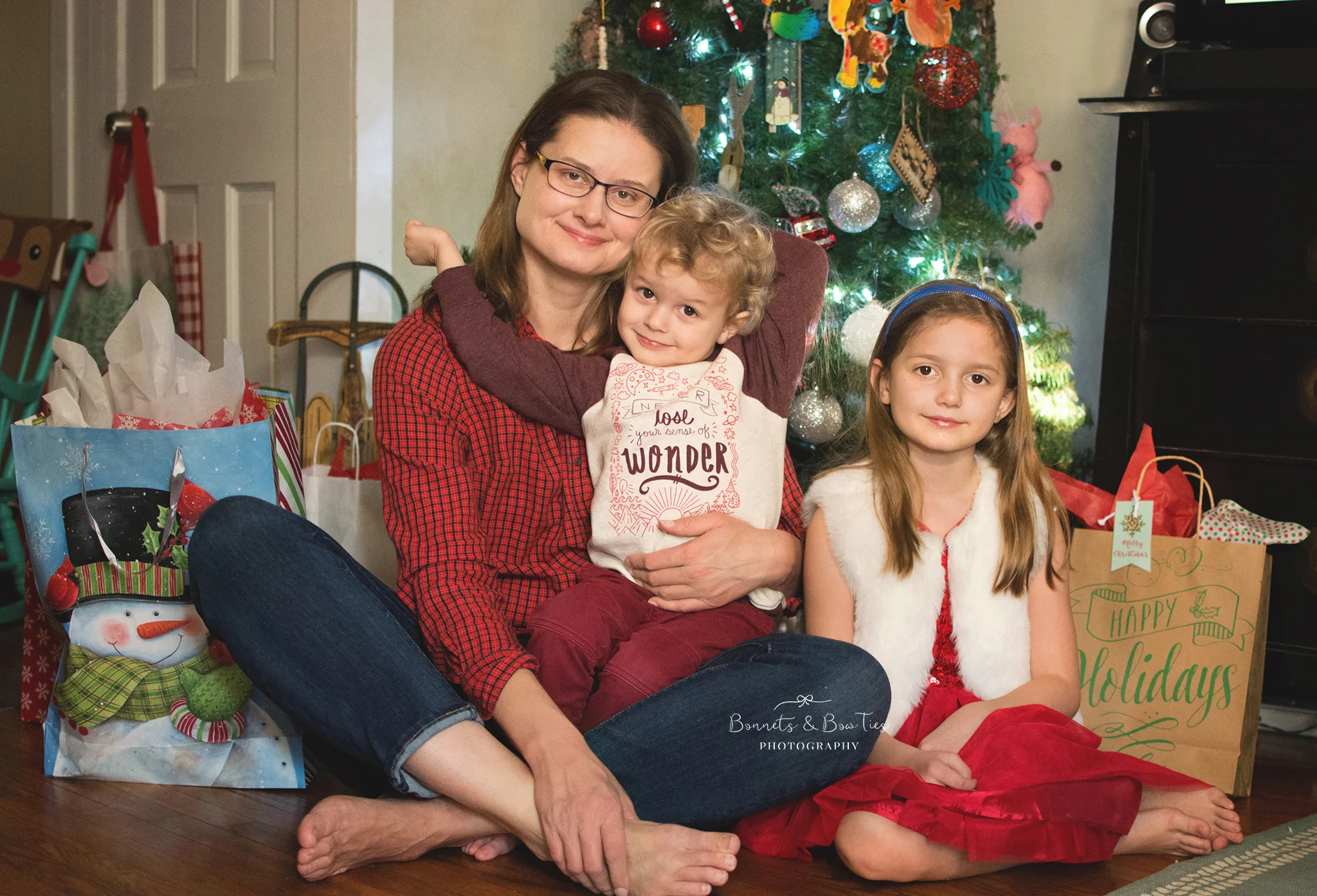 mother and children posing in front of christmas tree.jpg