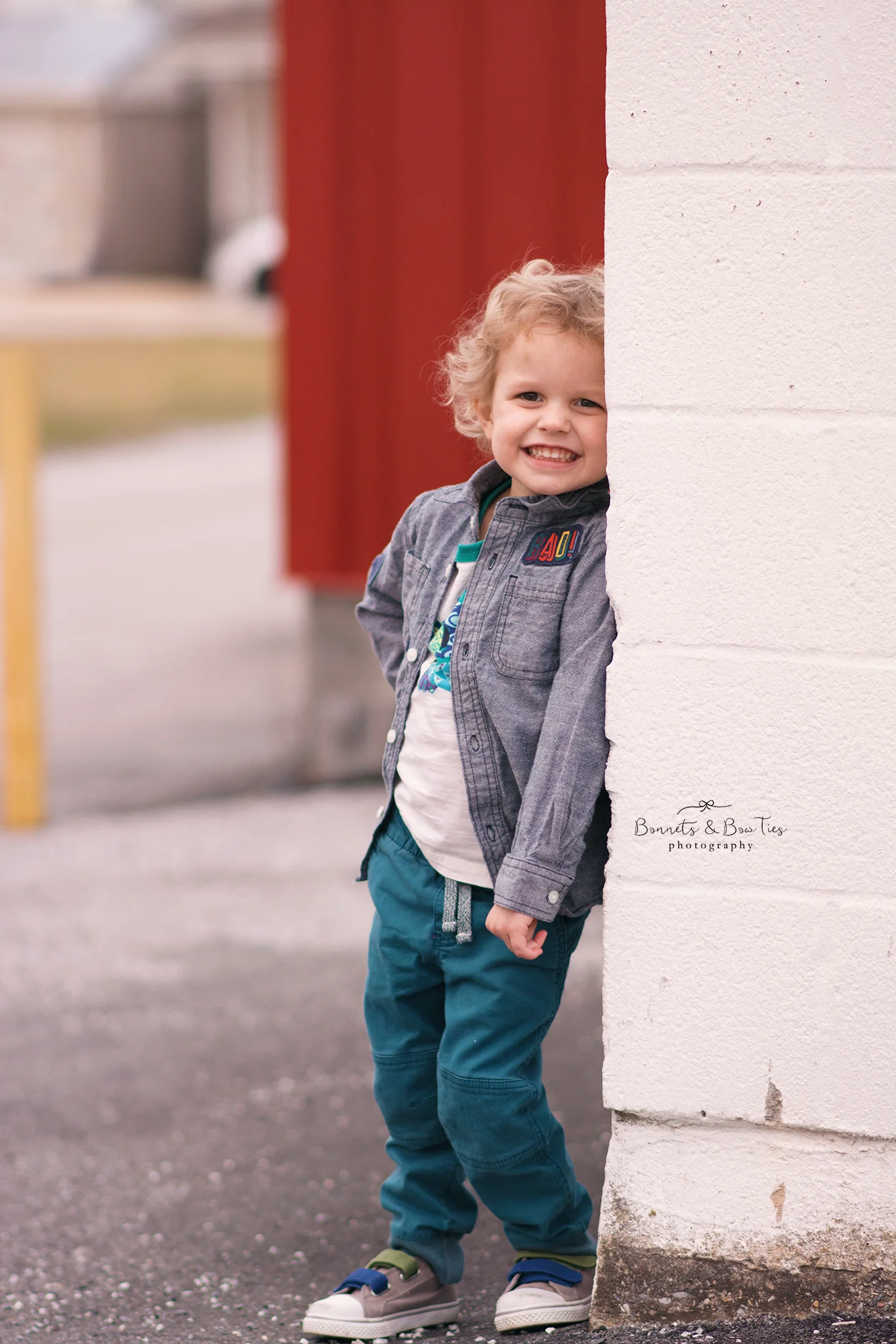 boy standing near red wall.jpg