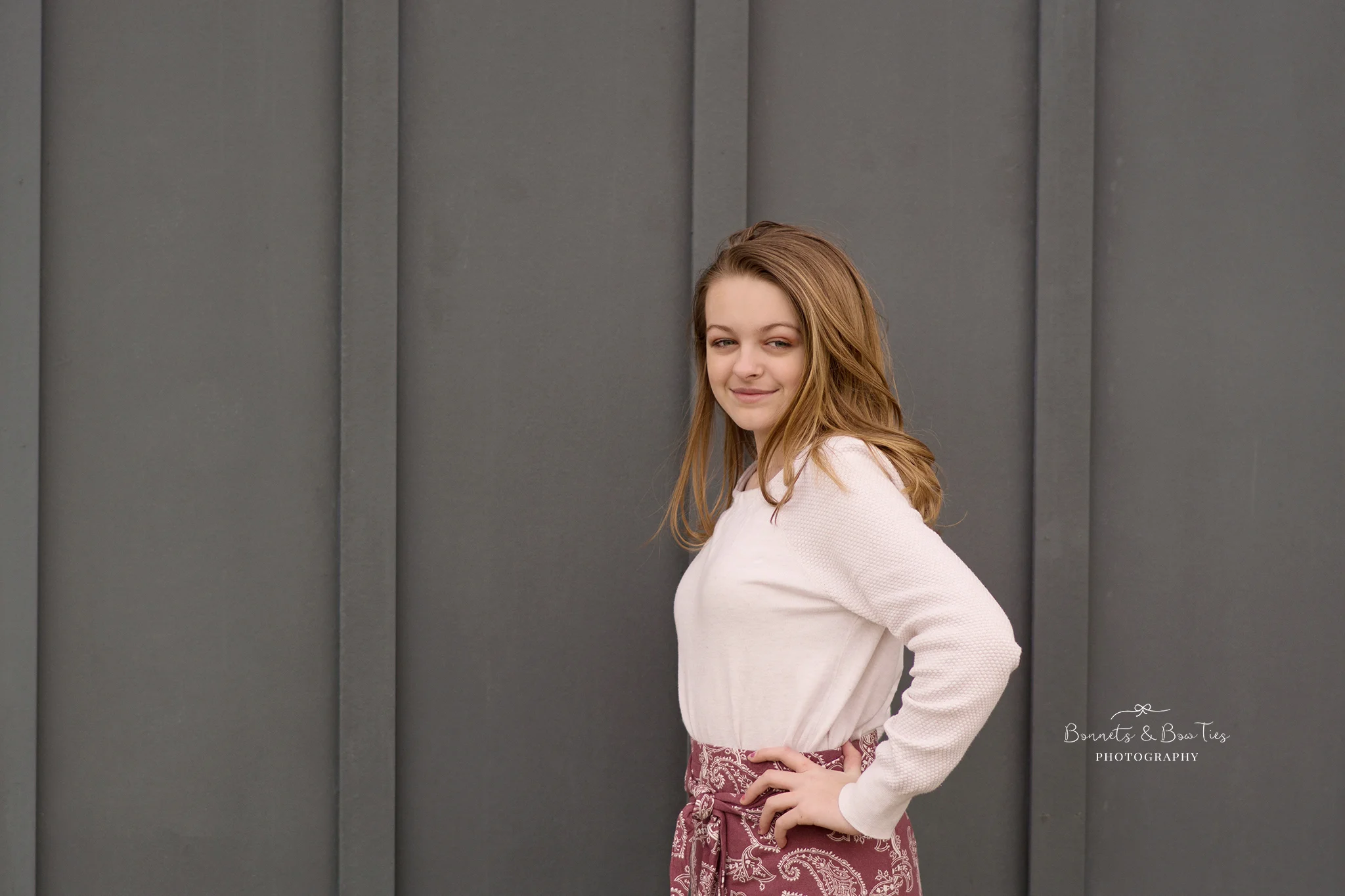 girl posing against grey wall.jpg