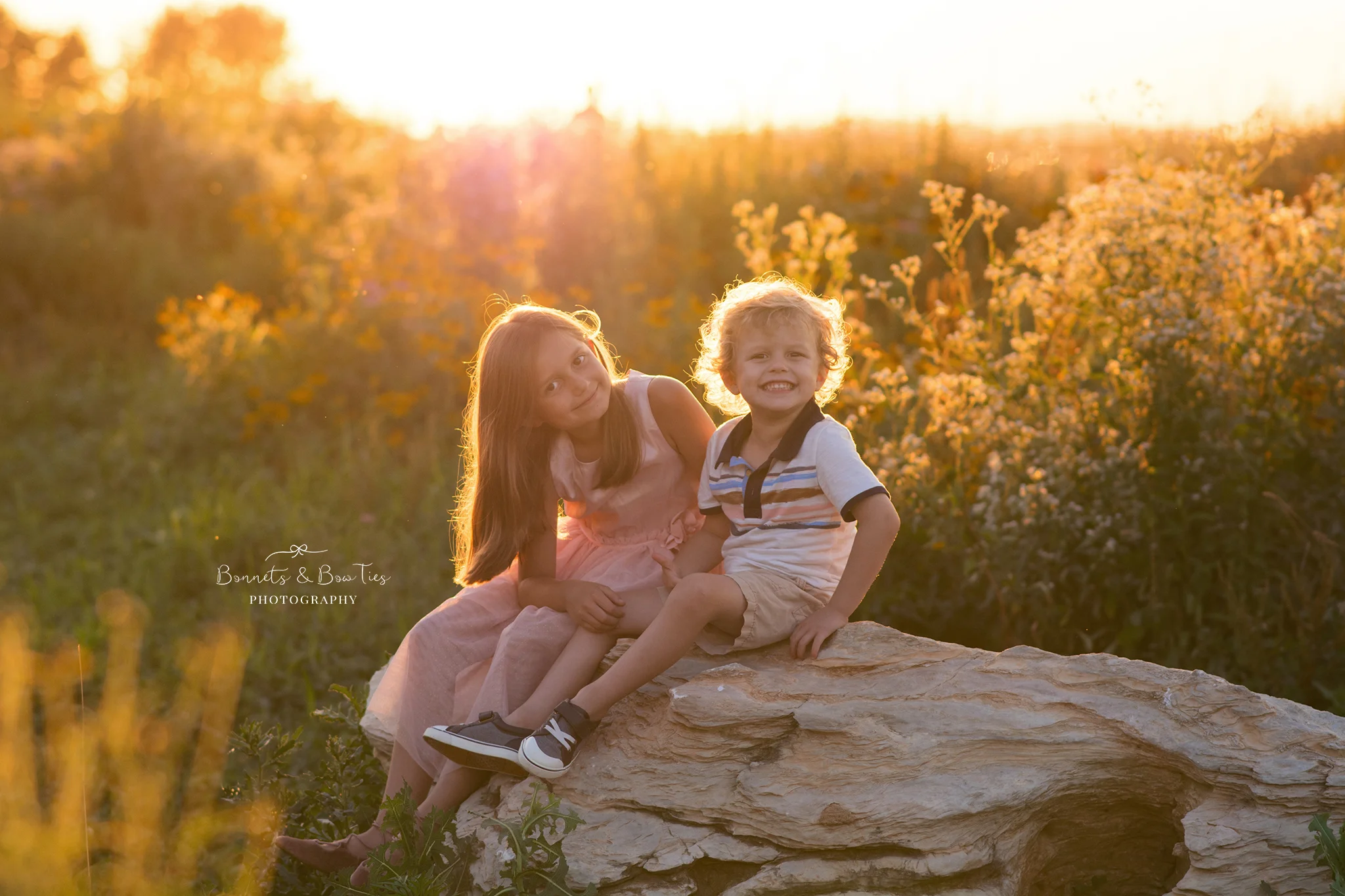 two kids sitting on rock.jpg