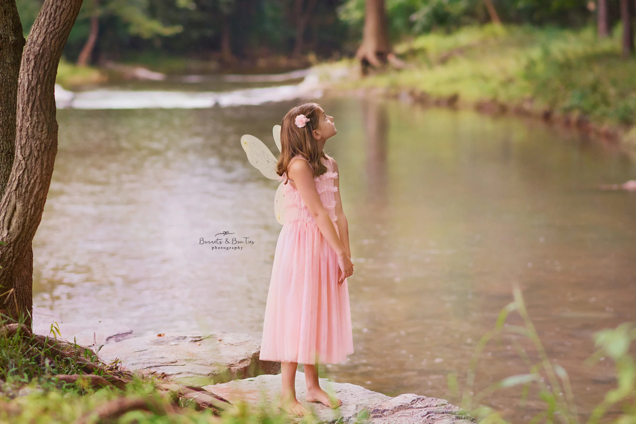 little girl in pink dress in creek.jpg