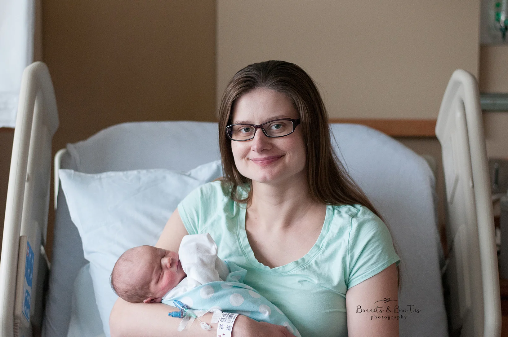 mother holding newborn baby at fresh 48 session.jpg