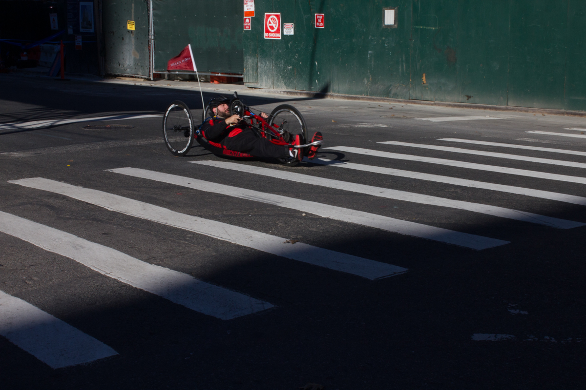 A handcyclist participating in the New York City Marathon speeds down Lafayette St. in Brooklyn.