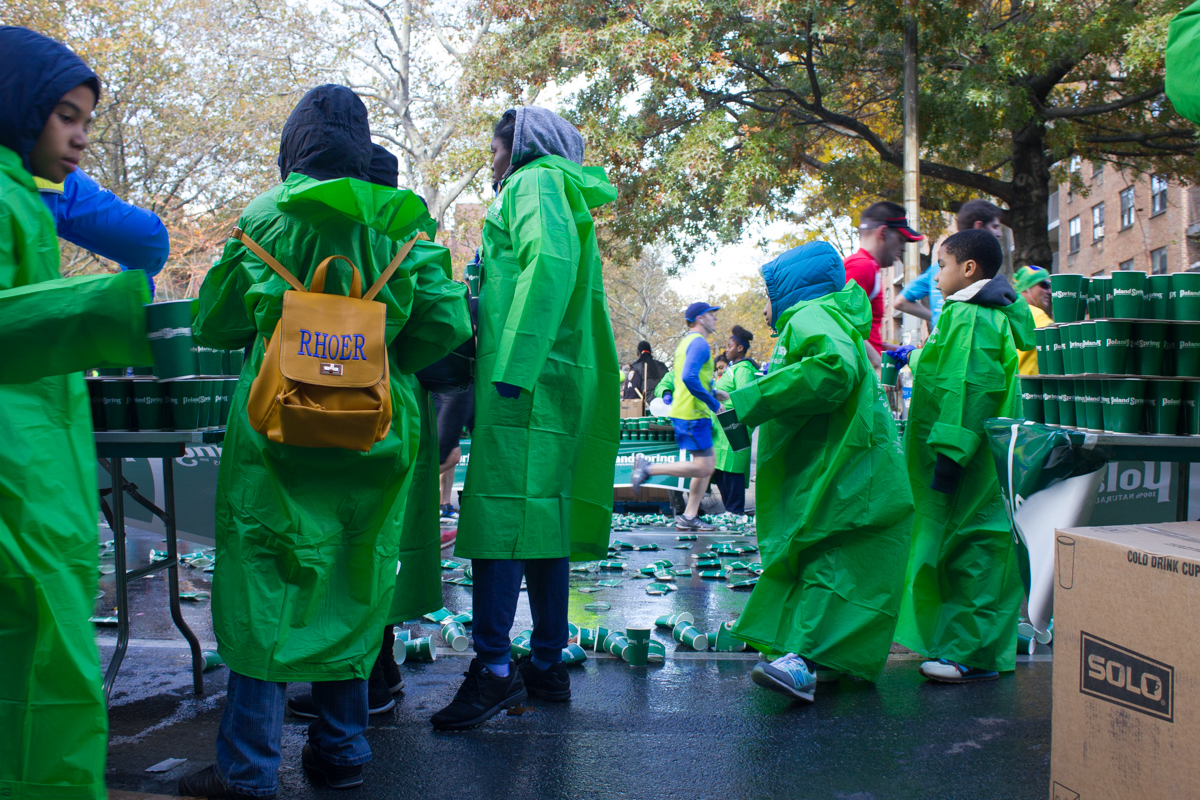 Volunteers wait at the eighth mile for more runners to give cups of water and Gatorade.
