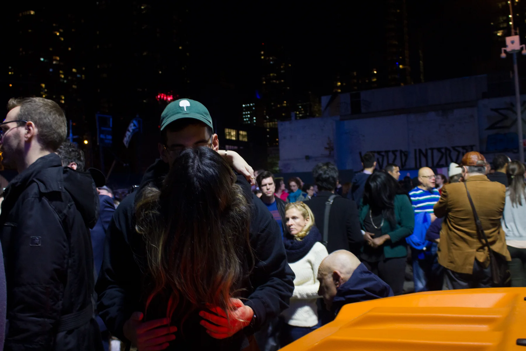 A couple kiss upon finding one another outside of the Javits Center.
