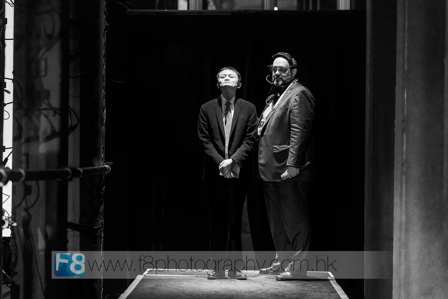 jack ma awaits on the runway with darren kerr , the executive producer of the event, before walking on stage for his discussion with mr obama.