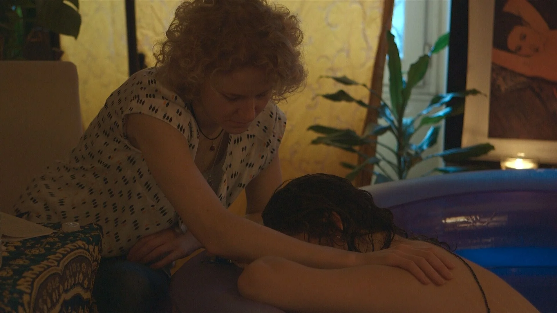 Women often bury their head and 'go inside themselves,' during the later stages of labour. In an undisturbed physiological birth women's bodies naturally flow into 'bearing down' to release their baby. To the trained eye and ear of an experienced Doula or midwife this 'transition' is evident. Image: Bea Moyes