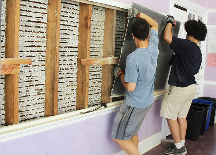 Julius van den Broek (6th Grade Class Teacher Paula van den Broek's son) and Gabriel Brown (Senior Staff Accountant Mark Brown's son) did a lot of heavy lifting this summer. All the elementary classrooms plus the orchestra room now feature brand-new blackboards! Thank you to all the generous donors who made this important project possible.