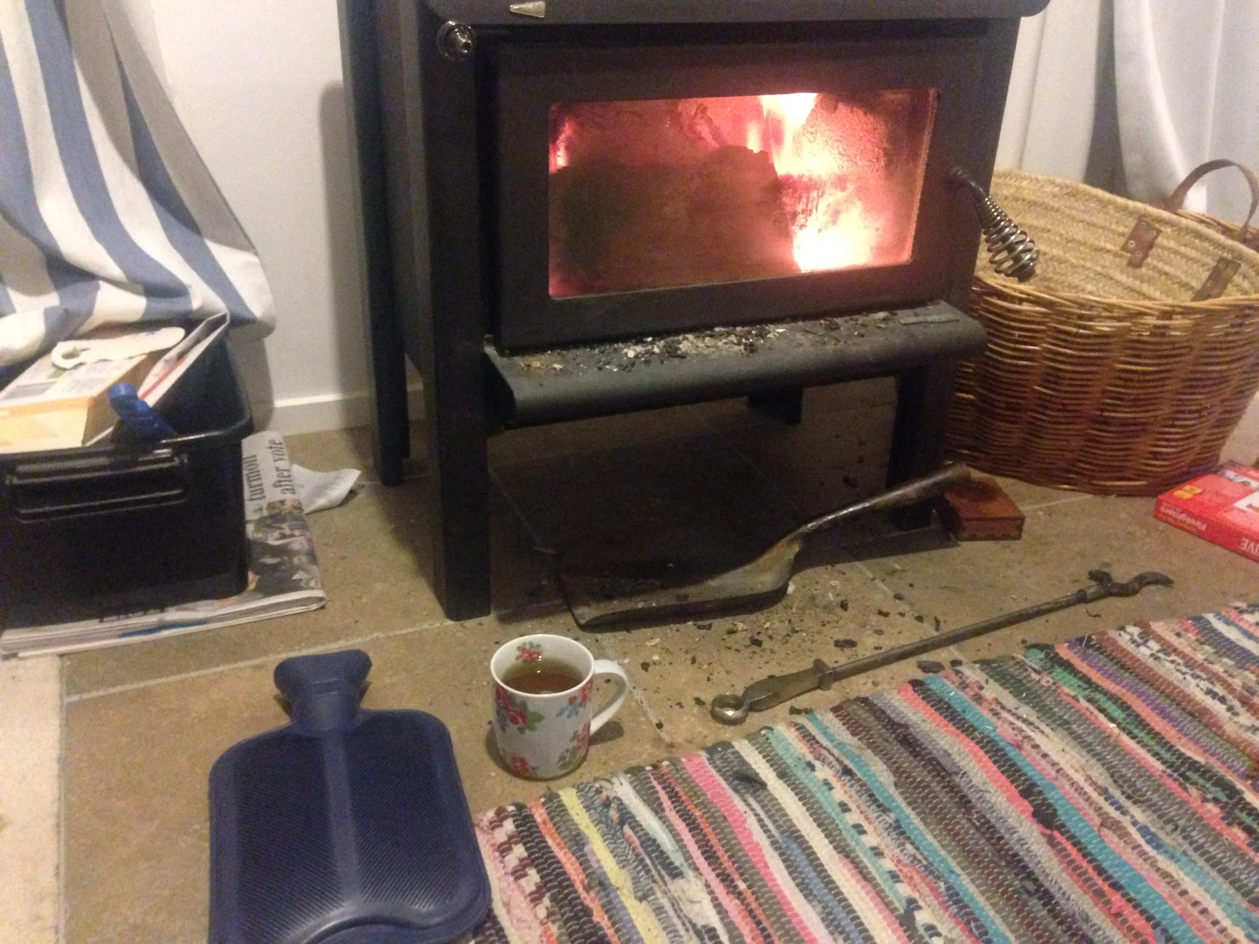 New Zealand winter starter kit: Hot water bottle, cup of tea, wood burning stove.