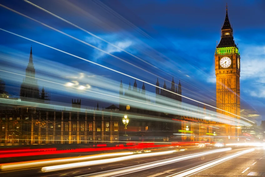 View of Big Ben from westminster bridge with lights from passing traffic