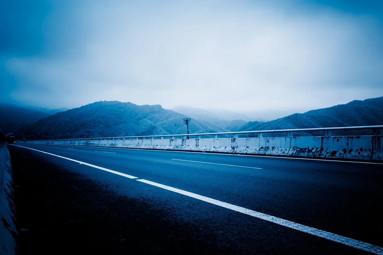 Empty road in mountains surrounded by cloud