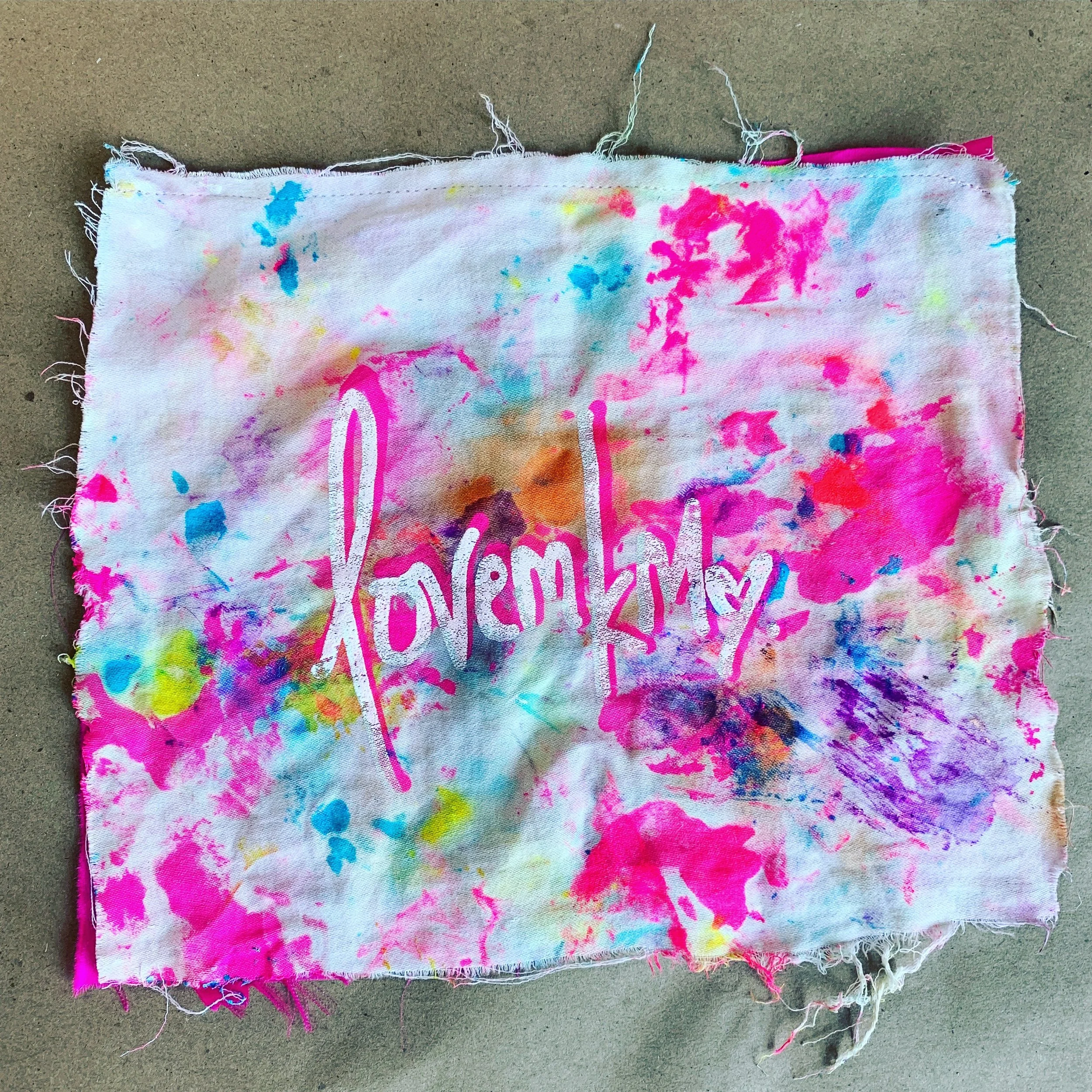 LOVEMKM logo scrap paint rag sewn onto silk charmeuse