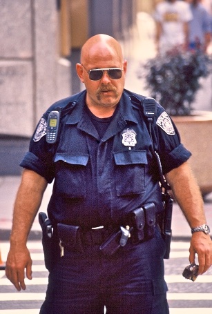 Bald and bold: a fully equipped NYPD cop, ready for everything. New York, USA.