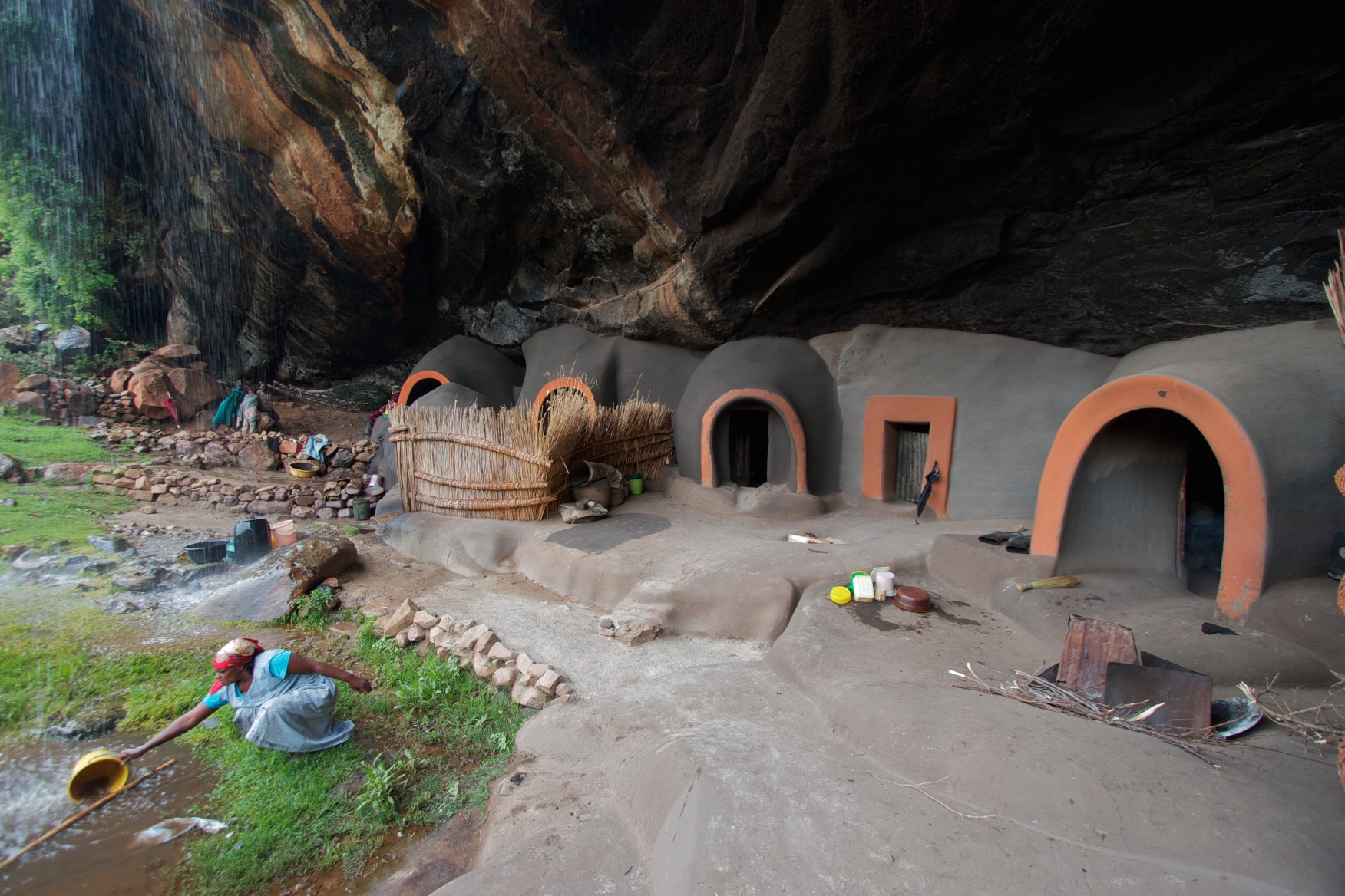 Under the waterfall: the families living beneath a precipice. Lesotho.