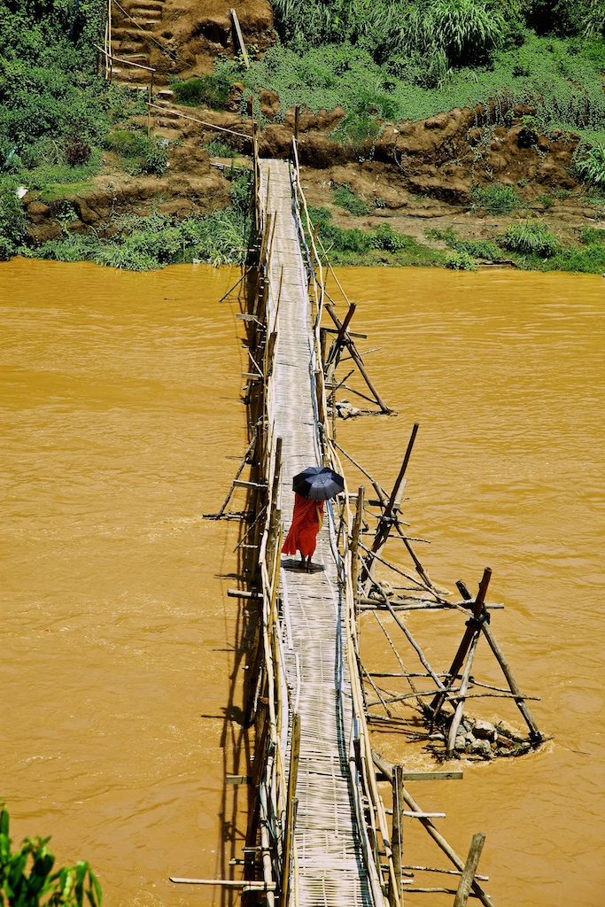 A muddied river bridge crossing. Luang Prabang, Laos.