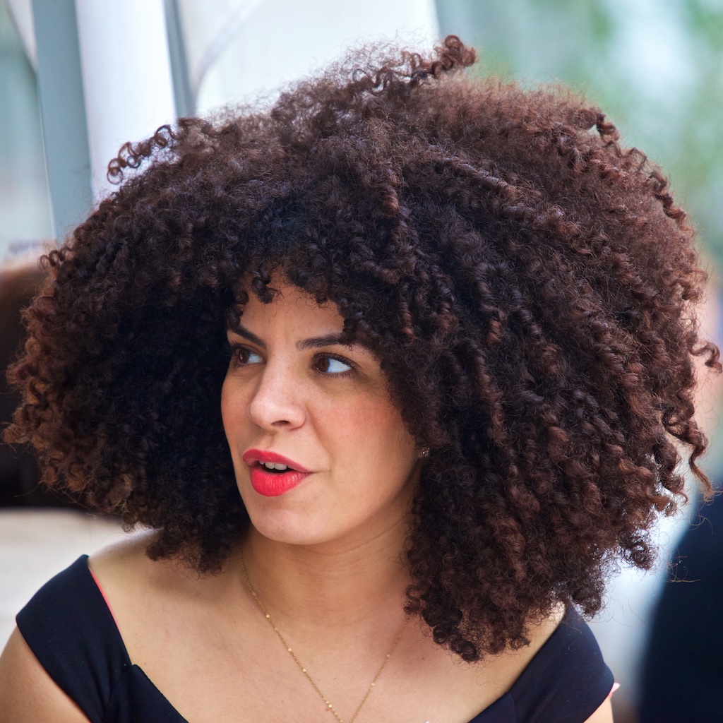 Red lips and corkscrew ringlets. Berlin, Germany.