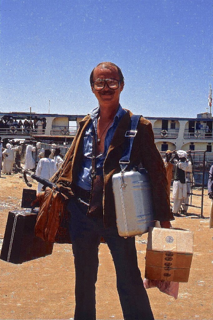 An improvising traveller getting off the boat in Sudan, having journeyed from Egypt.