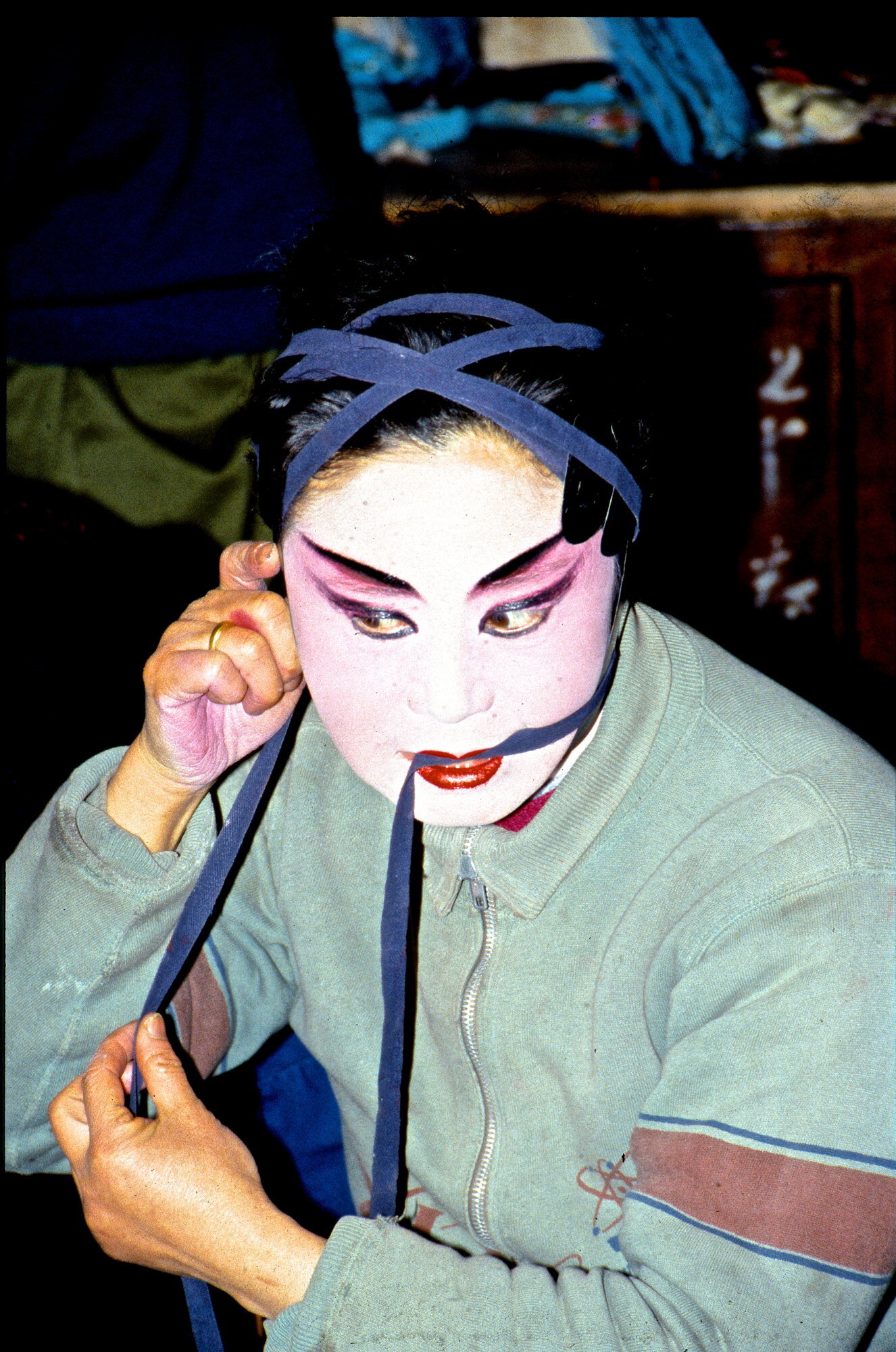 Chinese opera performer getting ready for the stage. Chengdu, China.