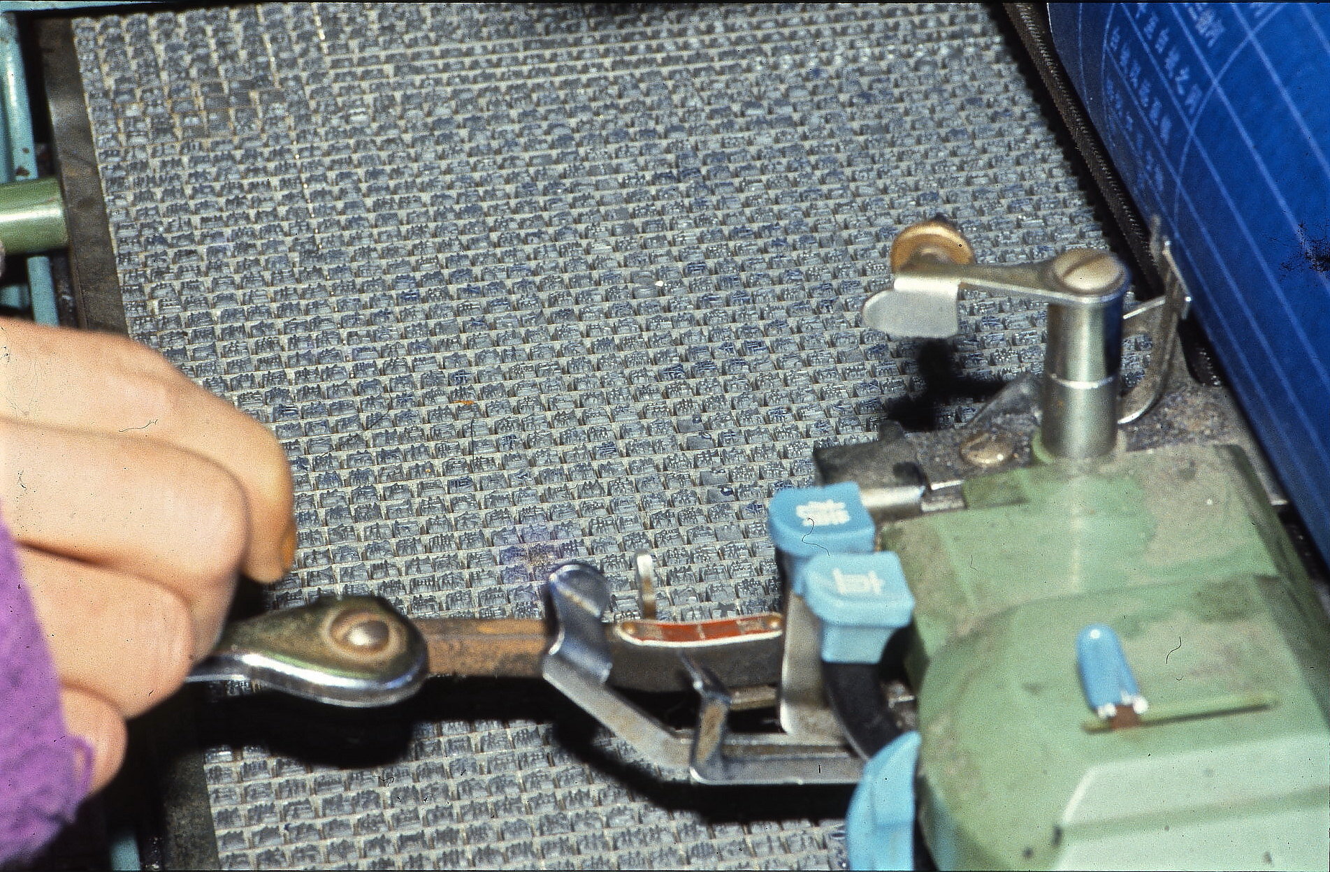 Writing with a subtle wrist on a Chinese typewriter with one of the 25 interchangeble trays that each contain 2,000 characters.