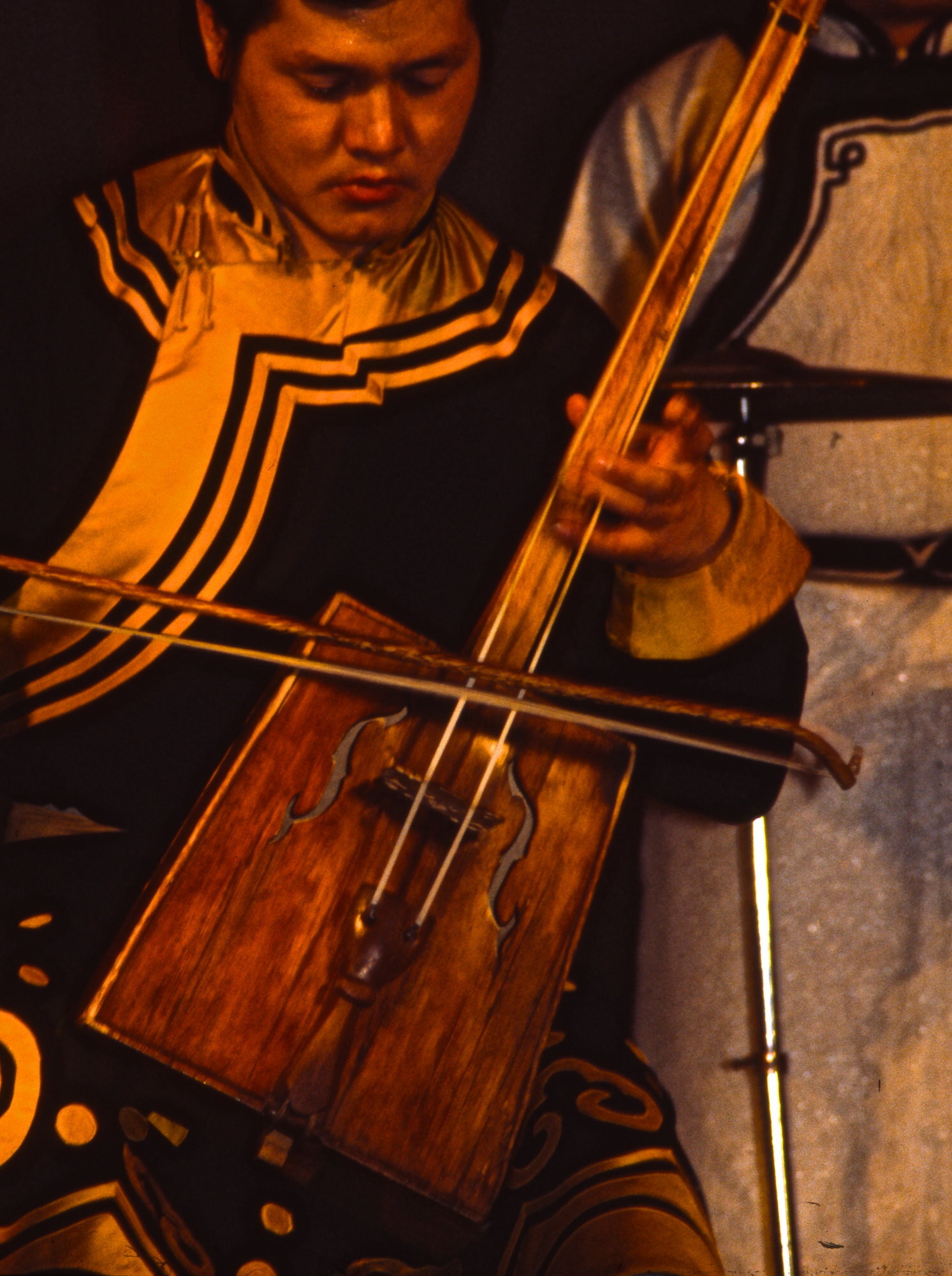 Two-stringed instrument in the hands of a Mongolian violinist.