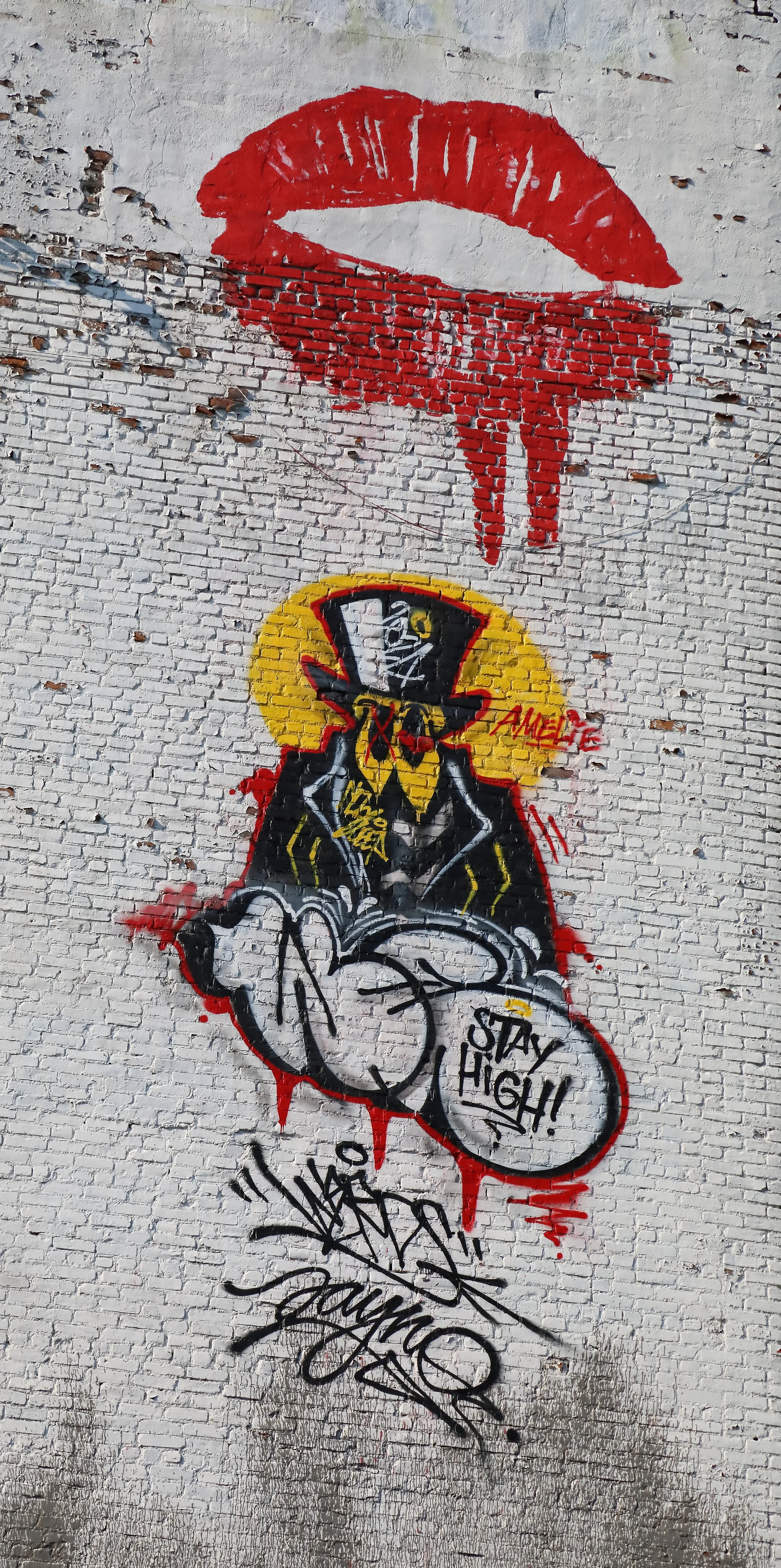Graffiti on a towering building in Soho, New York City, claiming the benefit of the altitude to inhale the ever-present marihuana smoke ascending from below. 